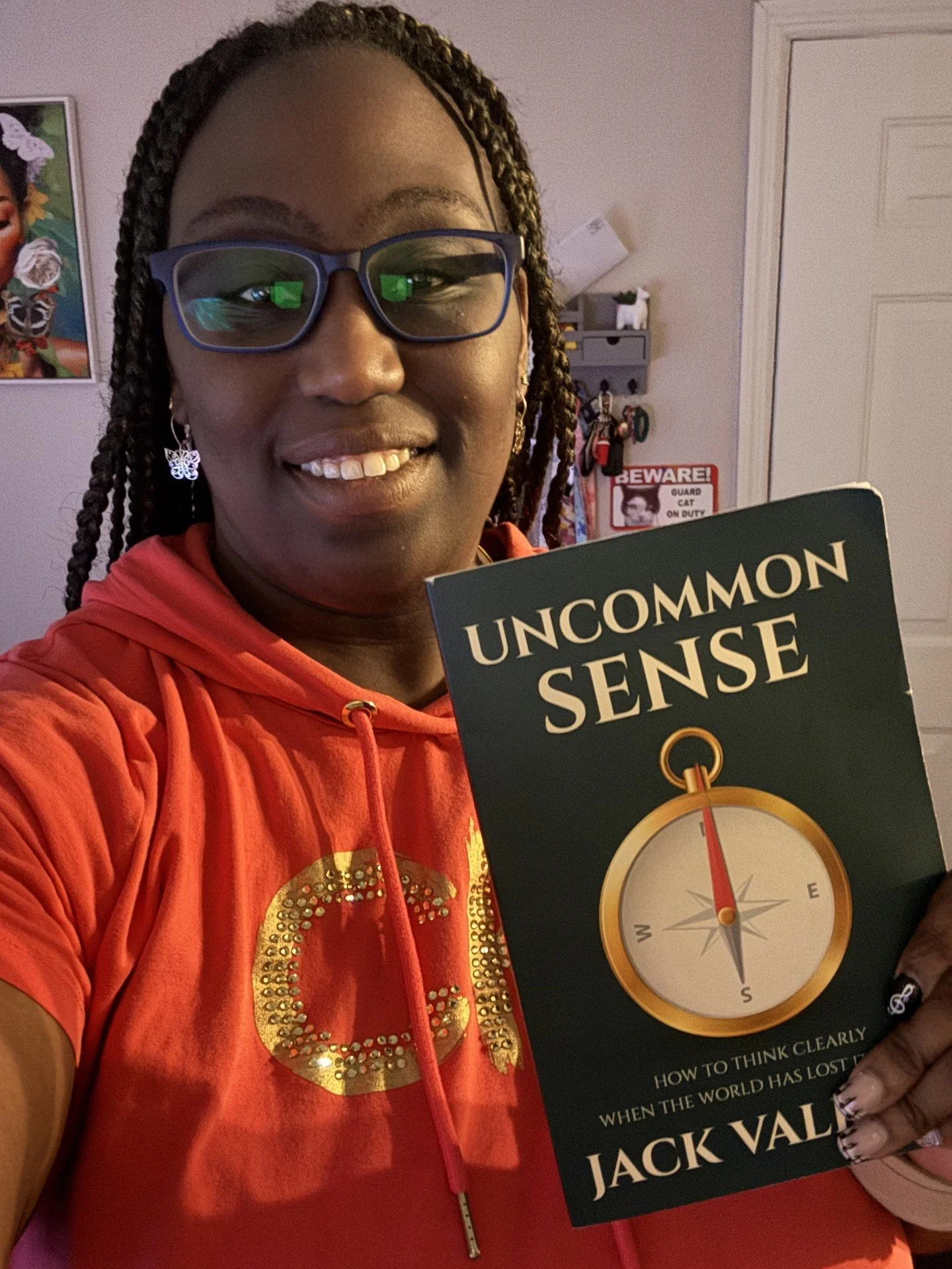 Ermithe, a longtime friend and former Martin County High School student, holding Jack Valerio’s book Uncommon Sense.