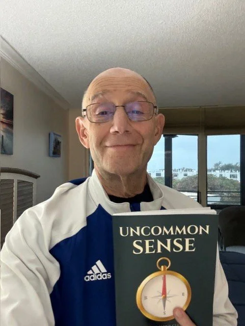 Al, former principal of Martin County High School, holding Jack Valerio’s book Uncommon Sense.