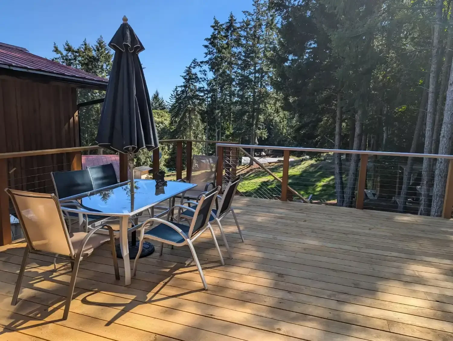 Cabin balcony with table, chairs and farm view