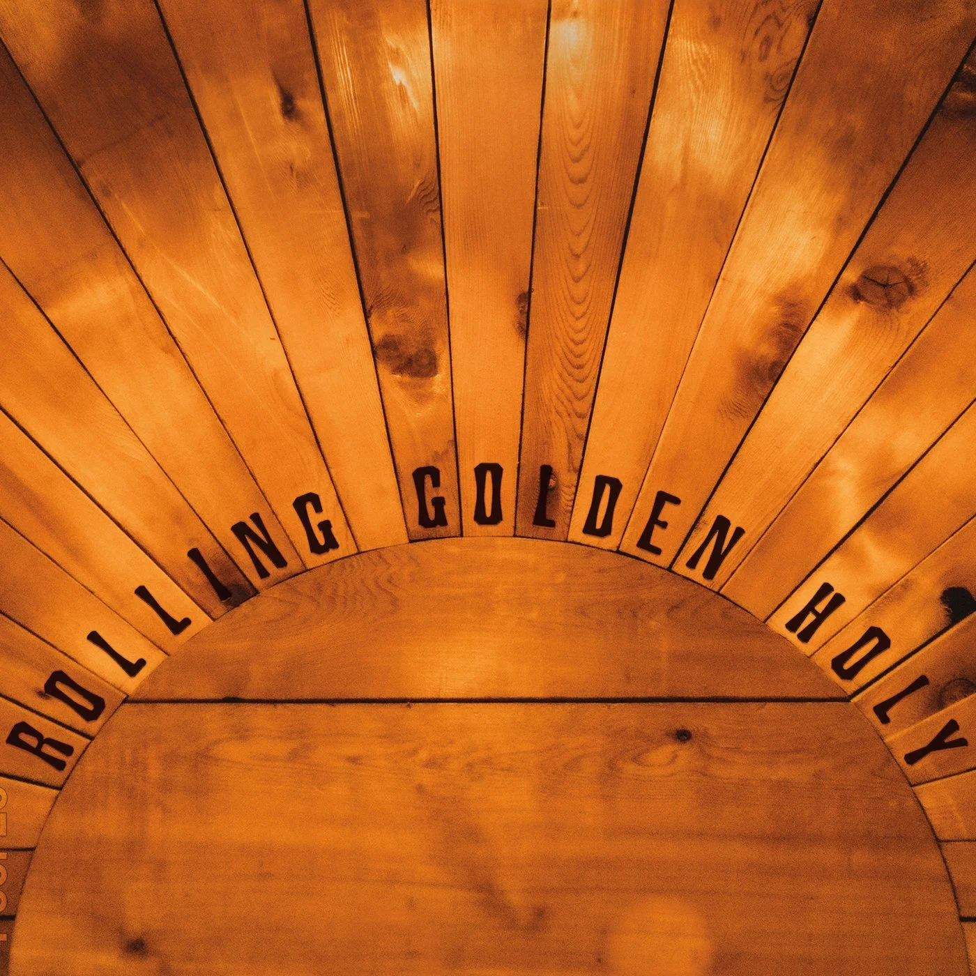 Wooden circular wall with the words 'BROADLINGTON GOLDEN HOLLY' written in black capital letters around the top portion.