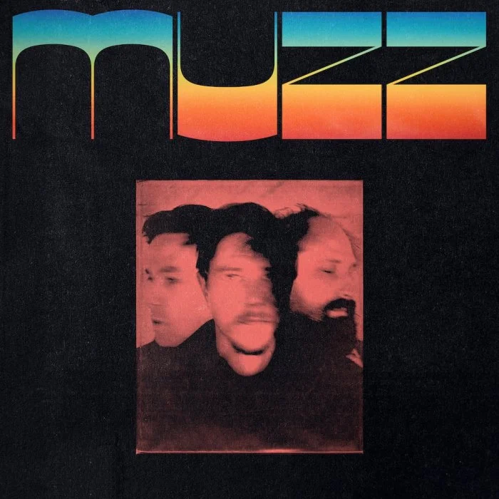 Dark background with colorful retro-style text reading "MUSE" at the top and a red-tinted, blurred photo of three men with expressive faces at the center.