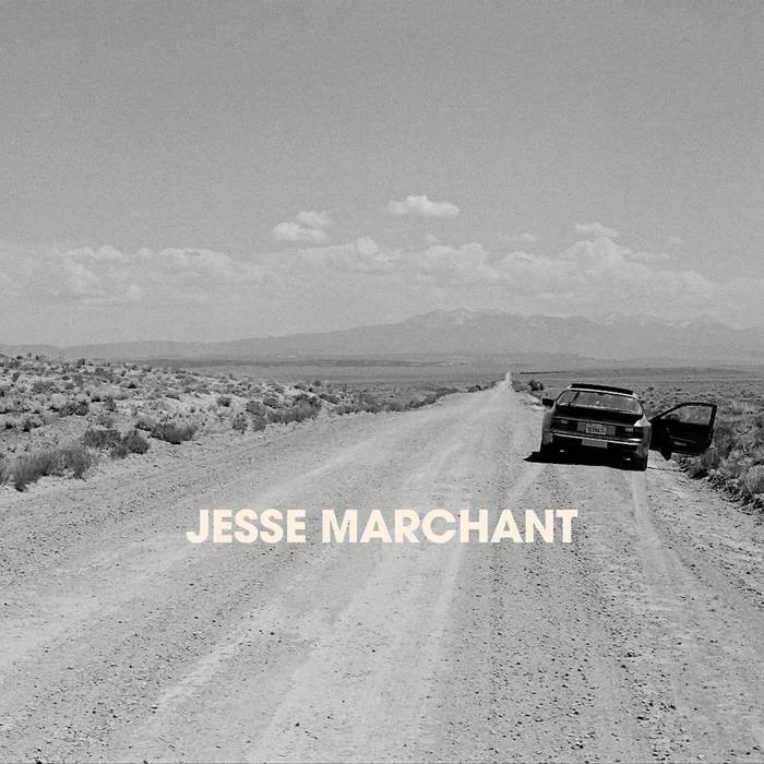 Black and white photo of a dirt road in a desert landscape with a car parked on the side and a mountain in the background, with the text 'JESSE MARCHANT' overlaid.
