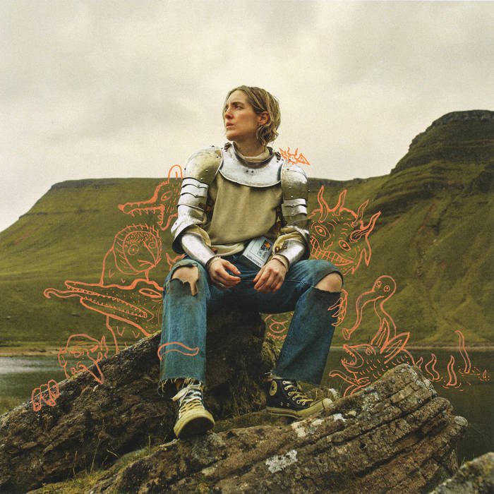 A young person dressed in armor sits on a large rock by a body of water, with a mountainous landscape in the background. There are red cartoonish dragon and monster sketches overlaying the scene.