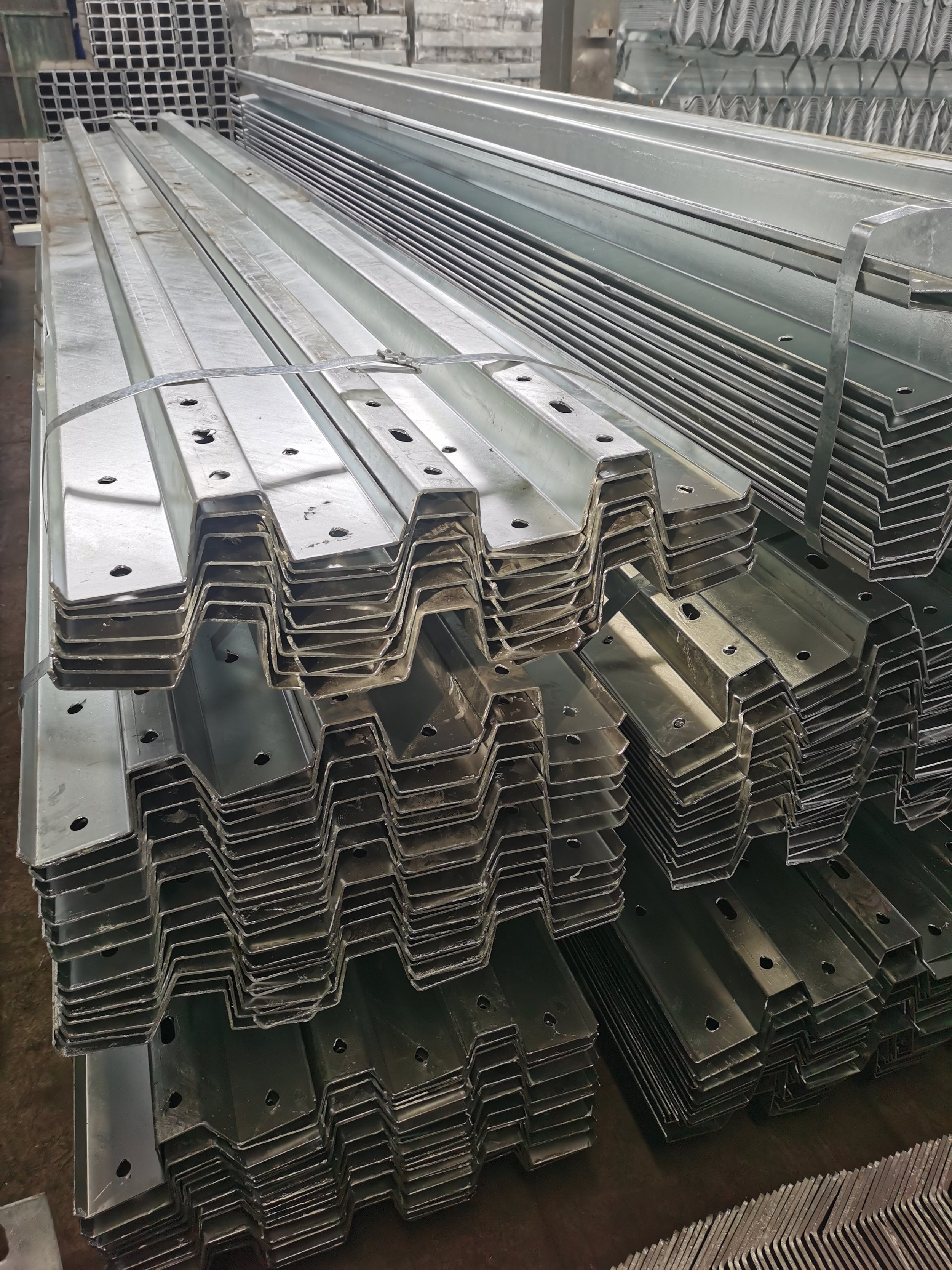 Stacked metal angle brackets or support beams in a warehouse.