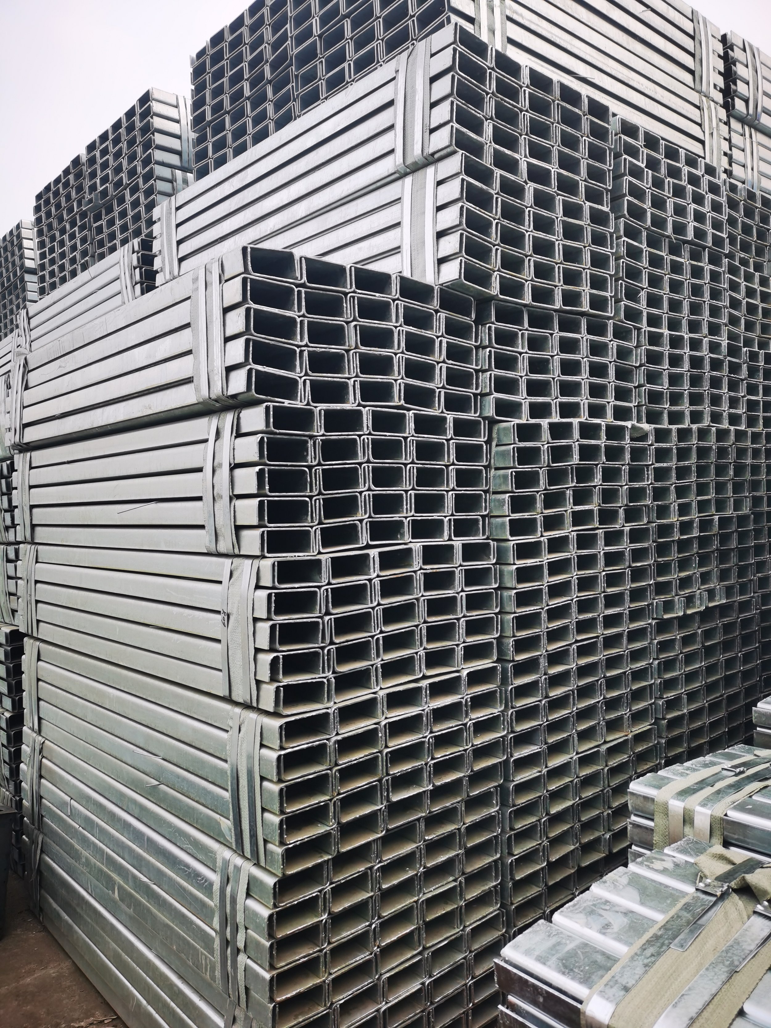 Stacked metal square tubing and I-beam sections.