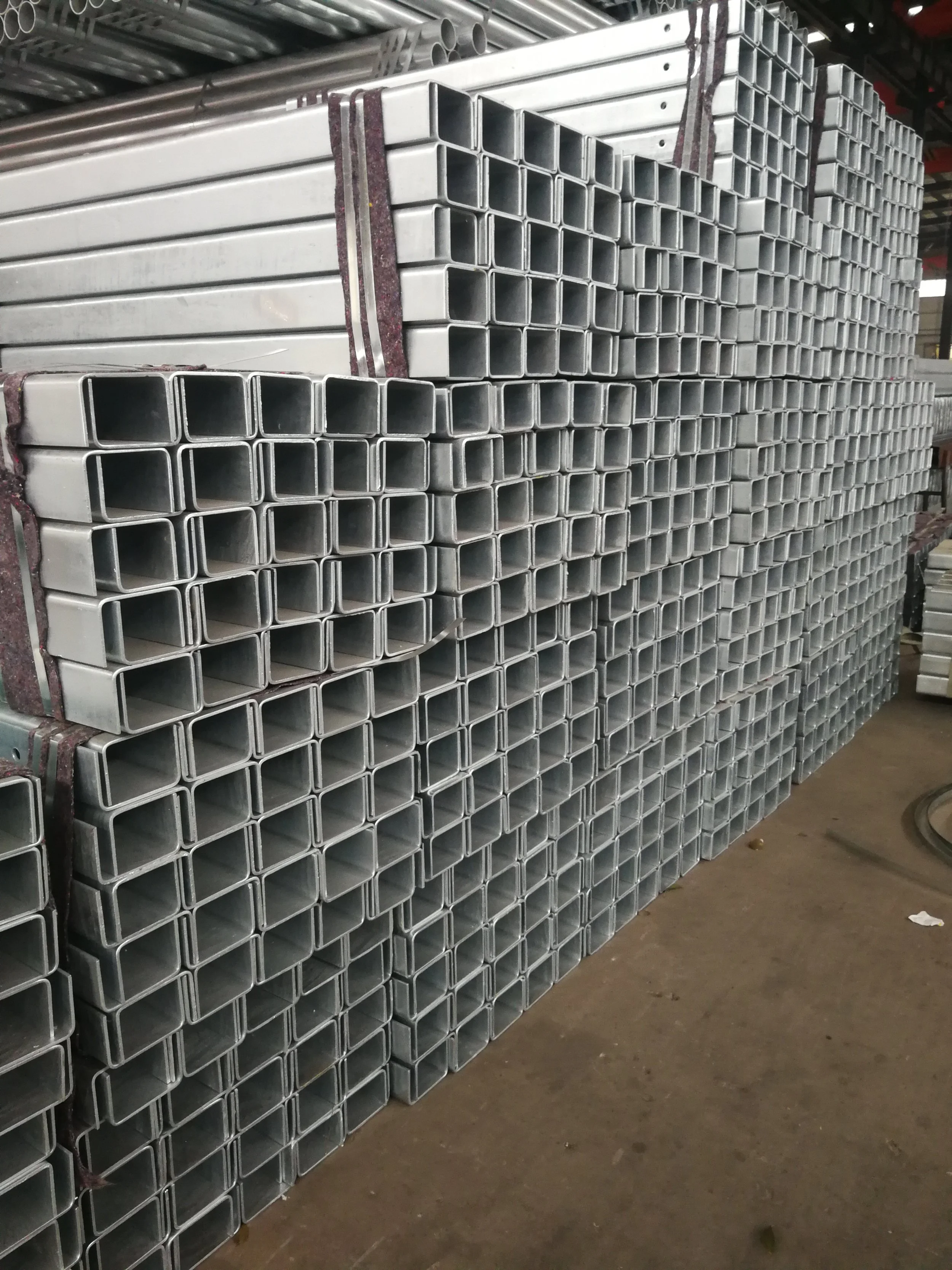 Stacked metal square tubes in a warehouse