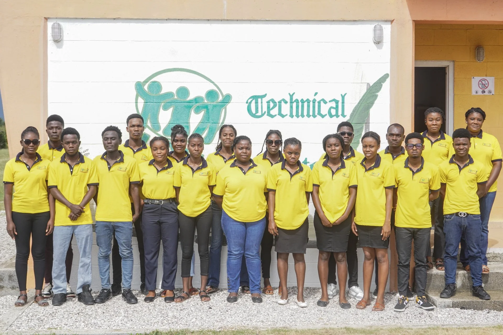 Large group of LSM Tech students standing together in front of their school