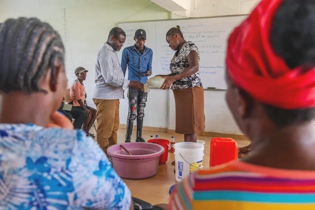 Parents in Haiti watch a life-skills presentation