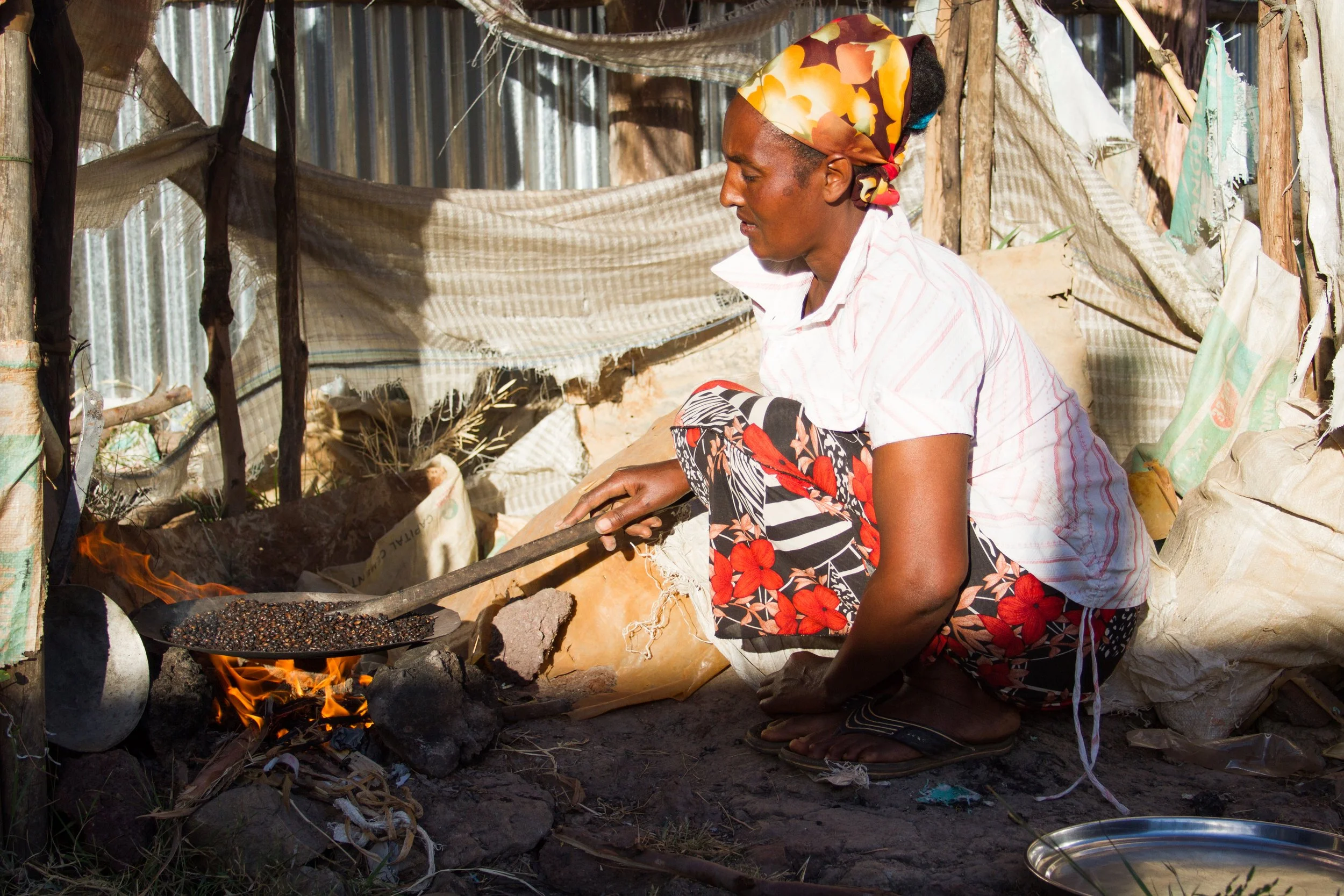 A young mother cooking outside