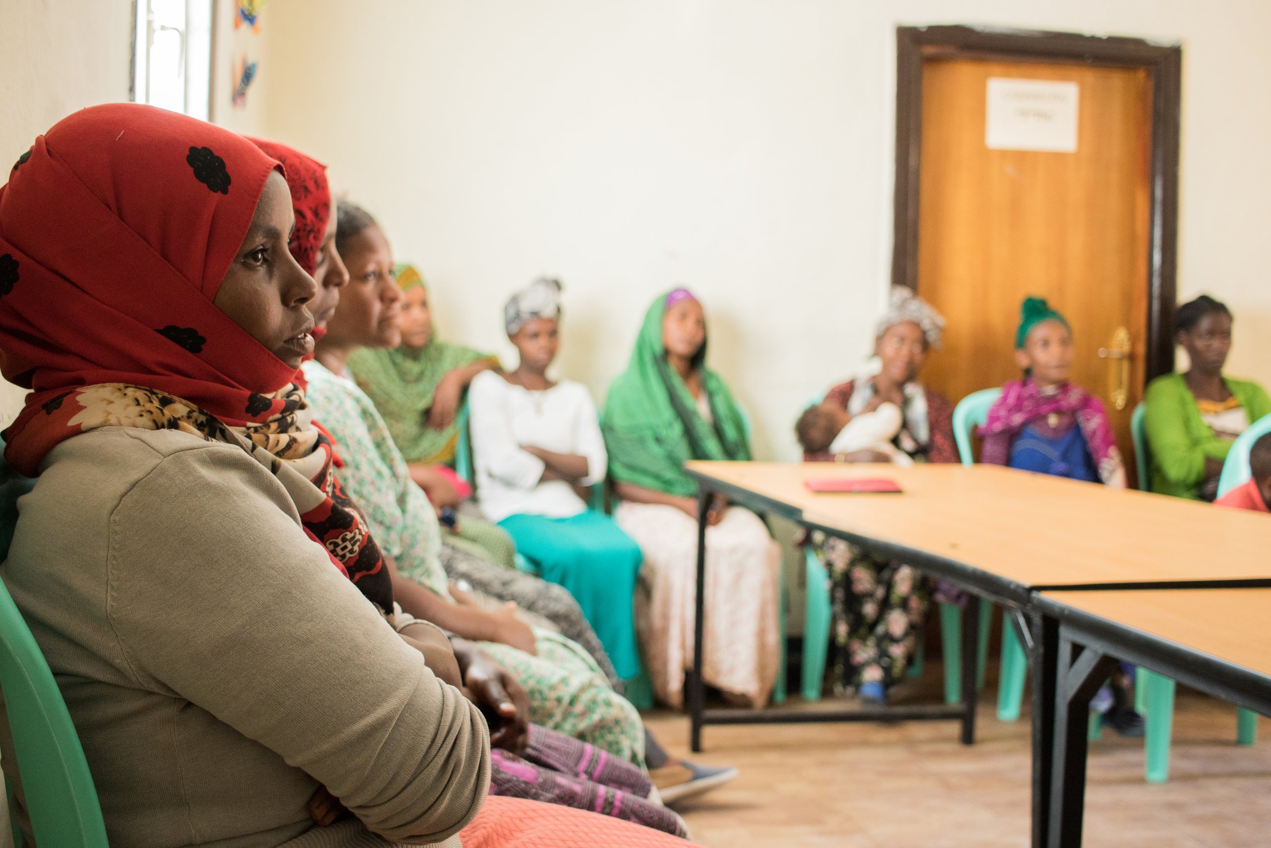 Mothers listening to a lecture in a classroom