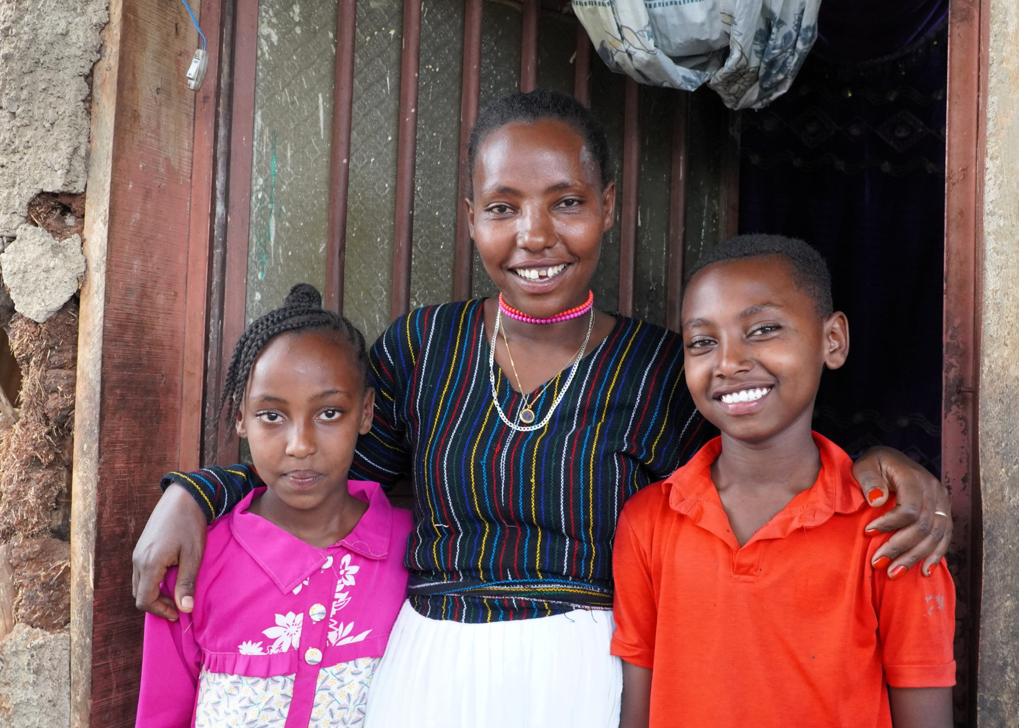 Young mother smiling with her little son and daughter