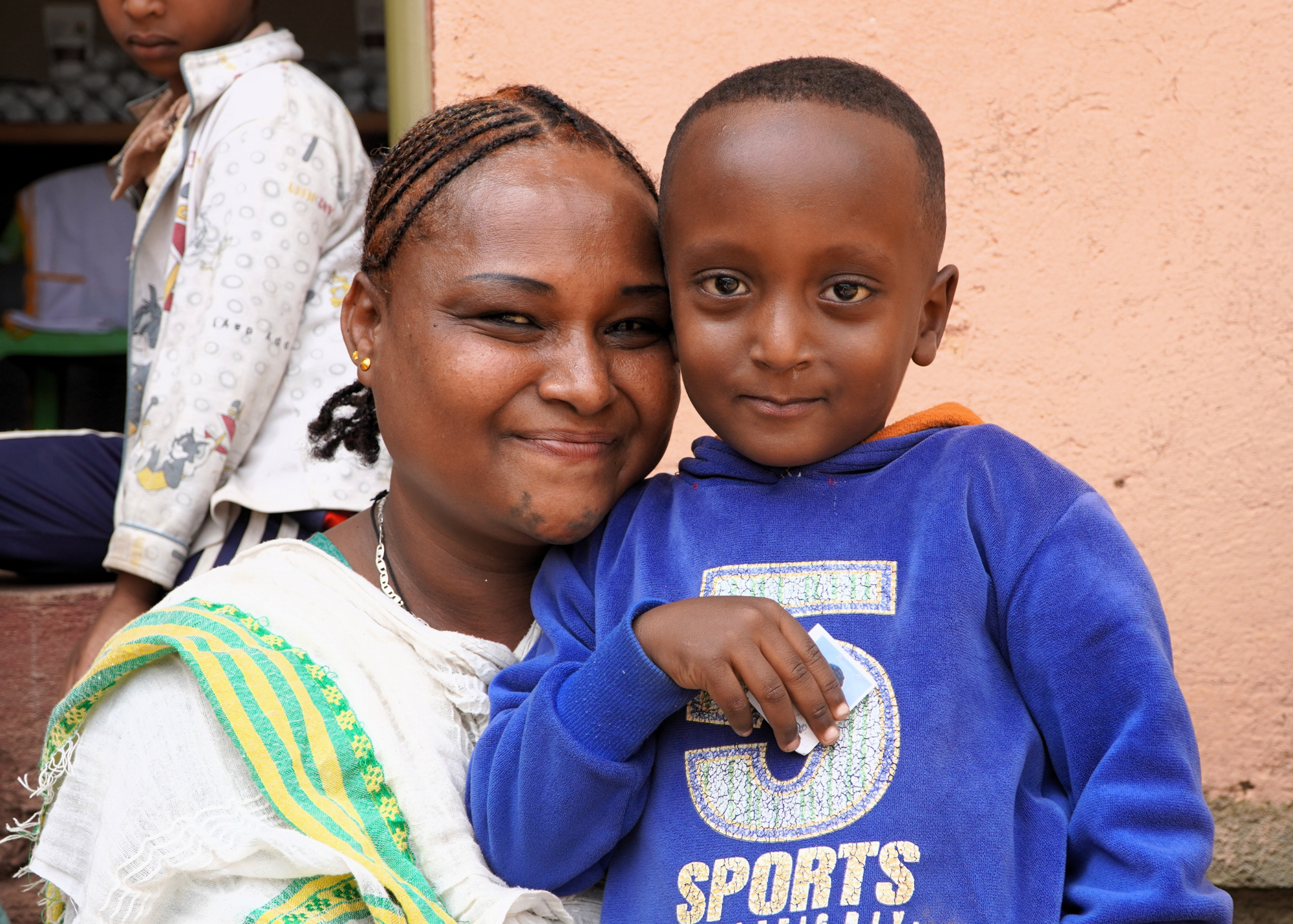 A young mother smiling with her little son