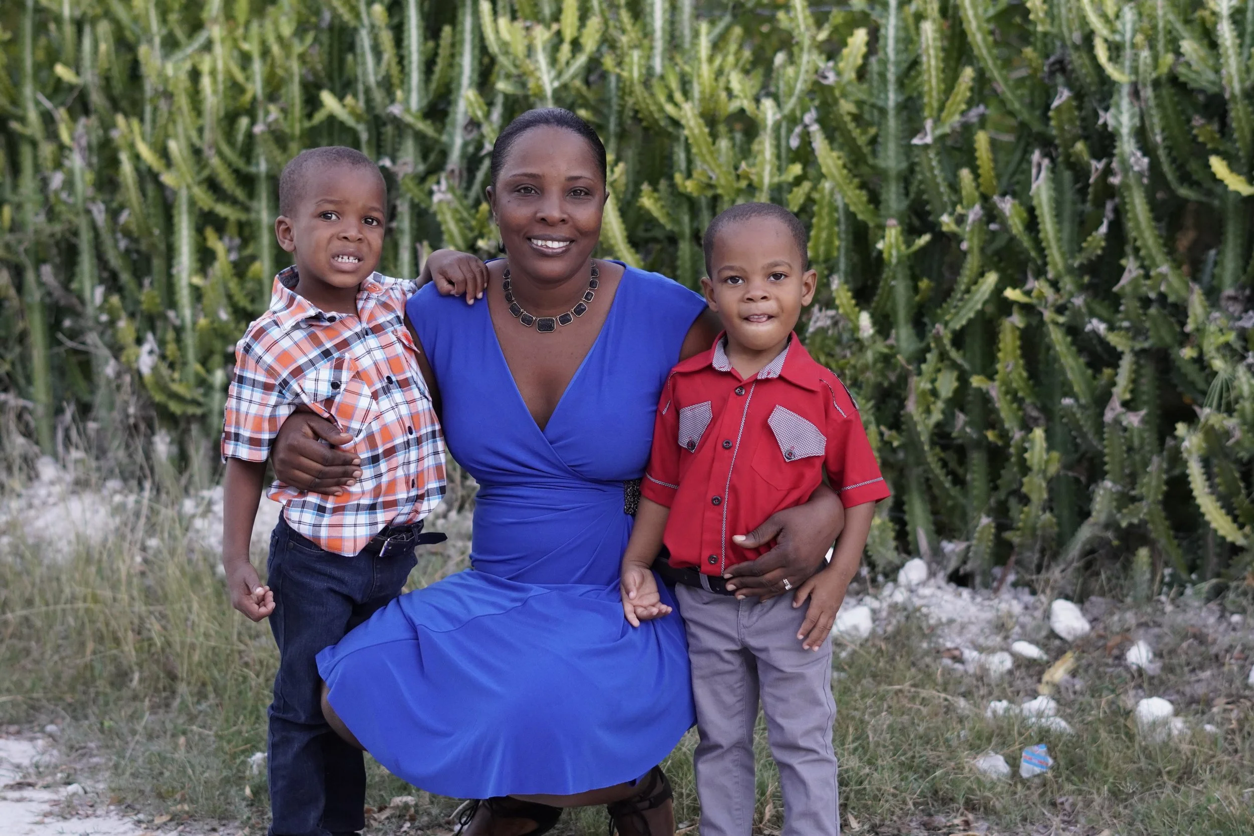 Haitian mother smiling and holding her two little boys