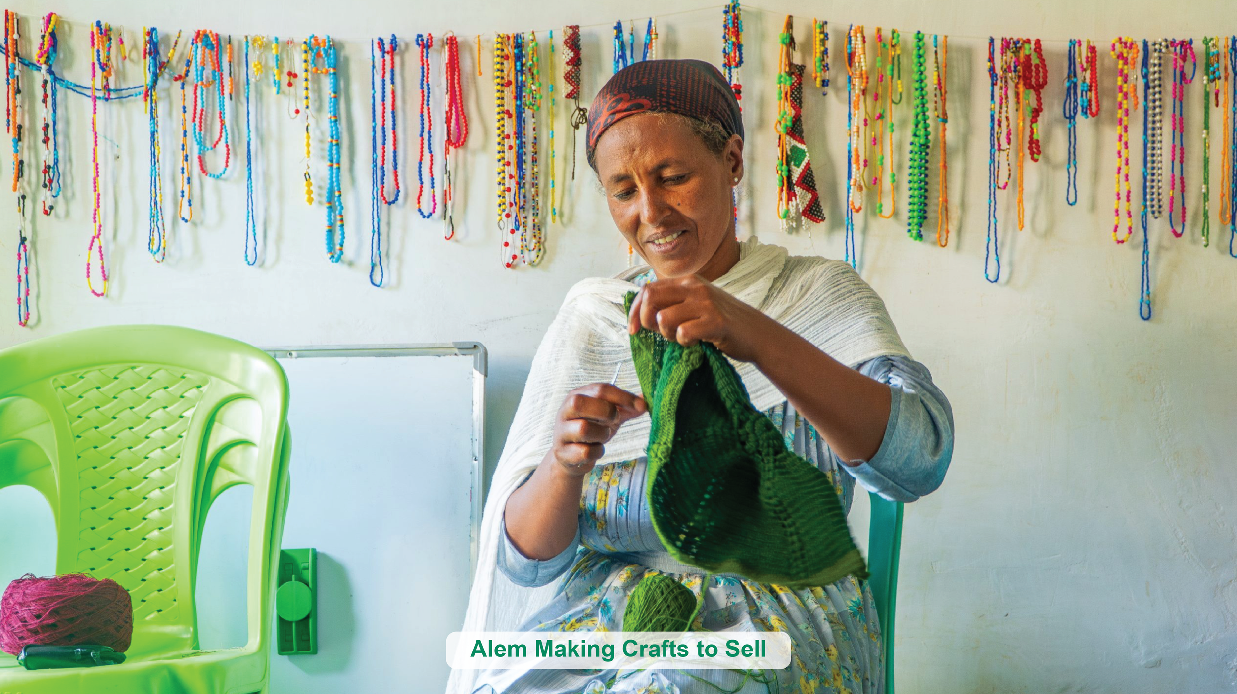 Alem using a thread and needle to create products to sell