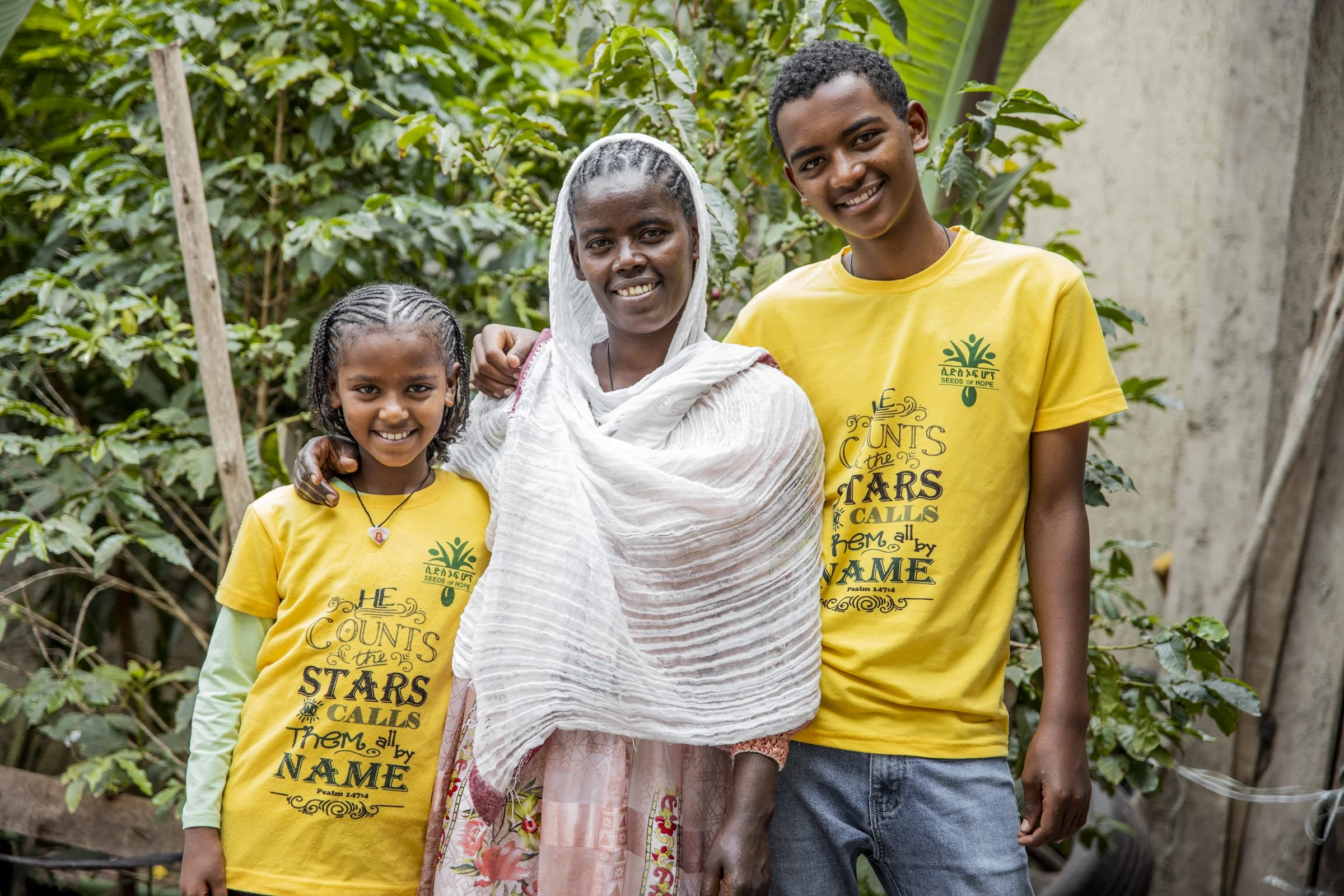 A mother smiling with her son and daughter