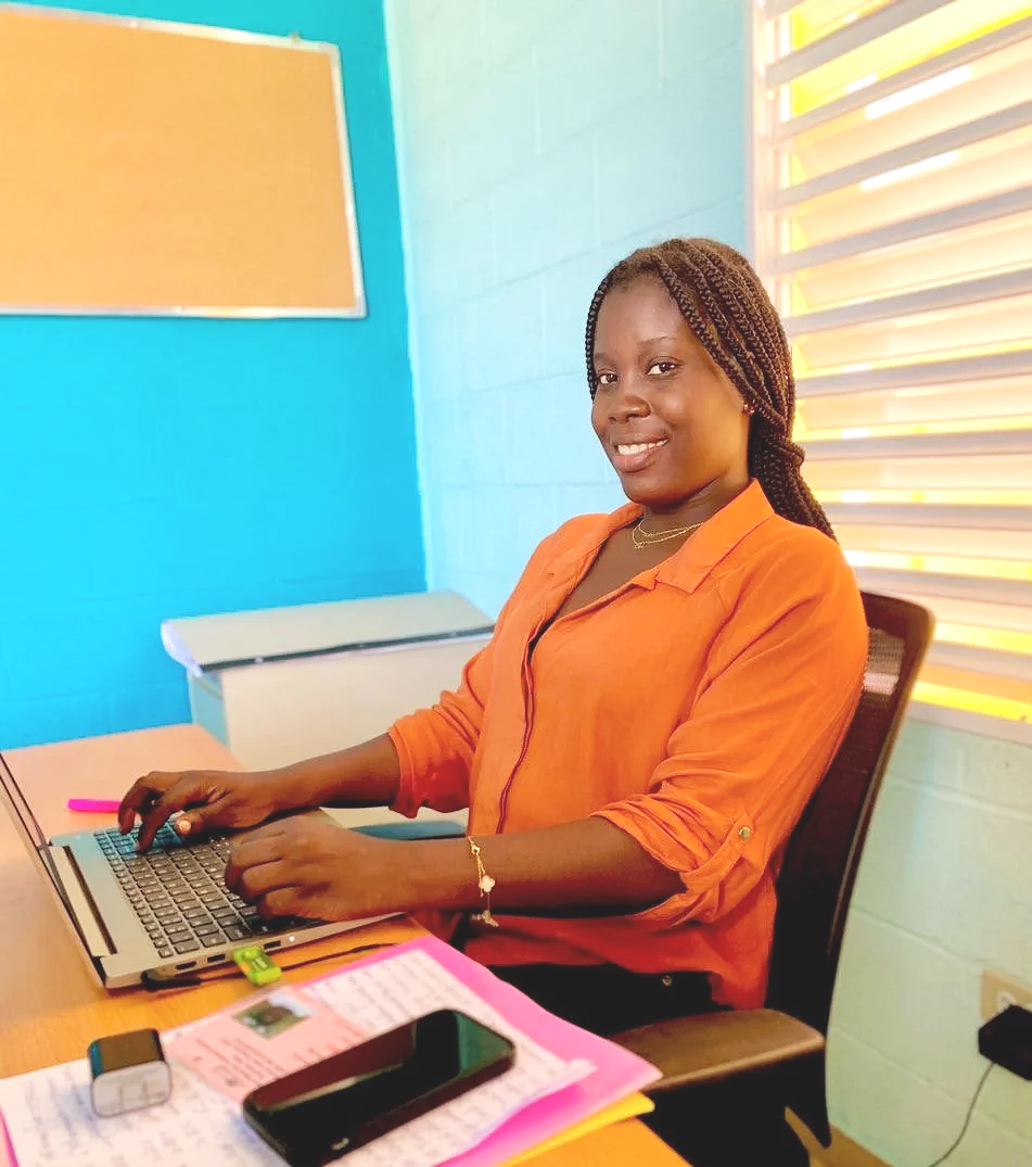 Young Haitian woman working on a laptop in her office. (Copy) (Copy)