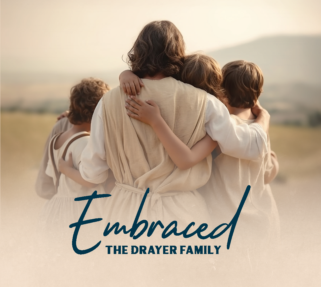 A man has his arms around three children who hold onto him as they all look at the mountains in the distance