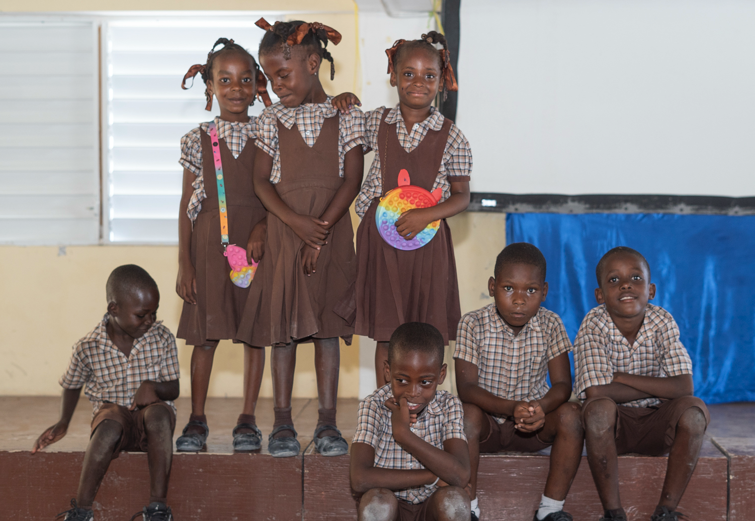 Little boys and girls pose in their school uniforms