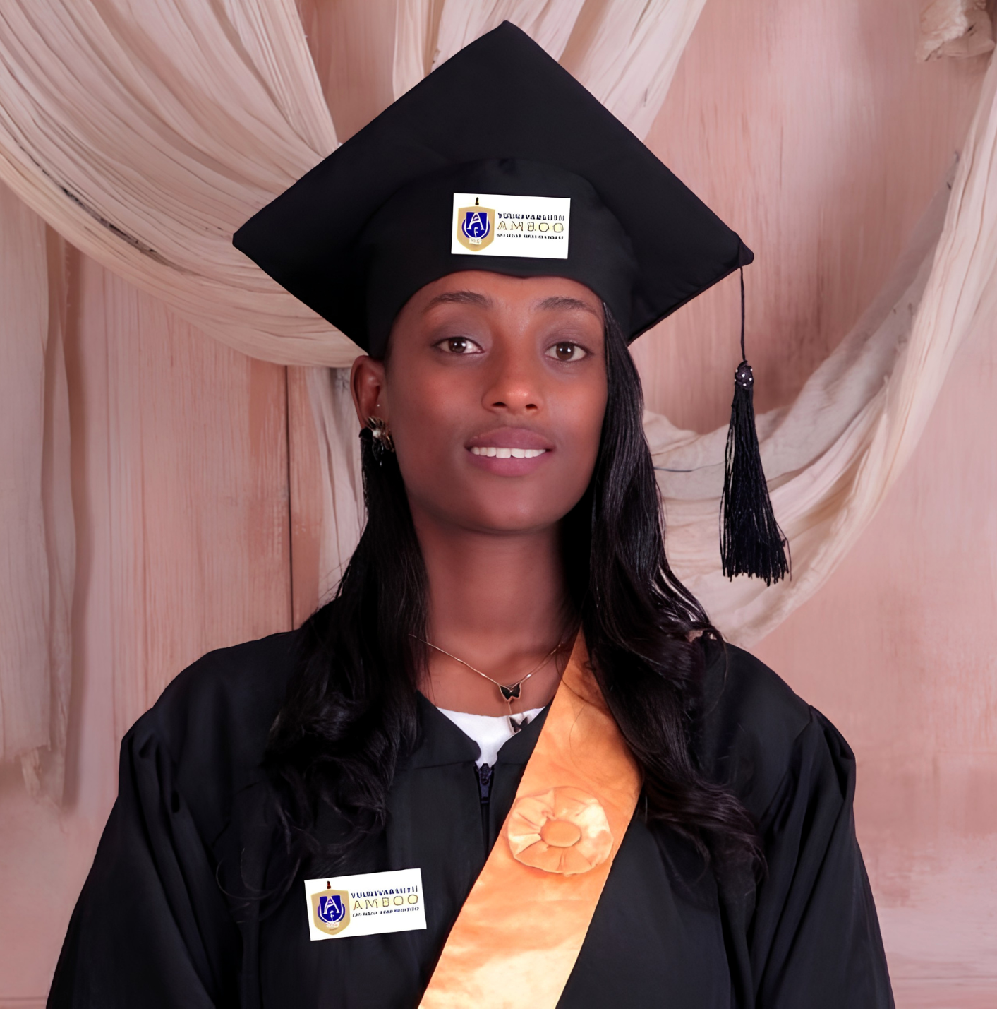 Konjit in her cap and gown after graduation