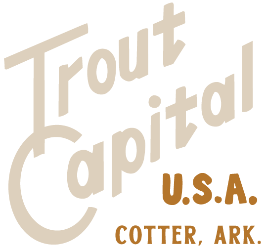 Stylized logo with the text 'Trout Capital U.S.A. Cotter, Ark.' in beige and brown colors.