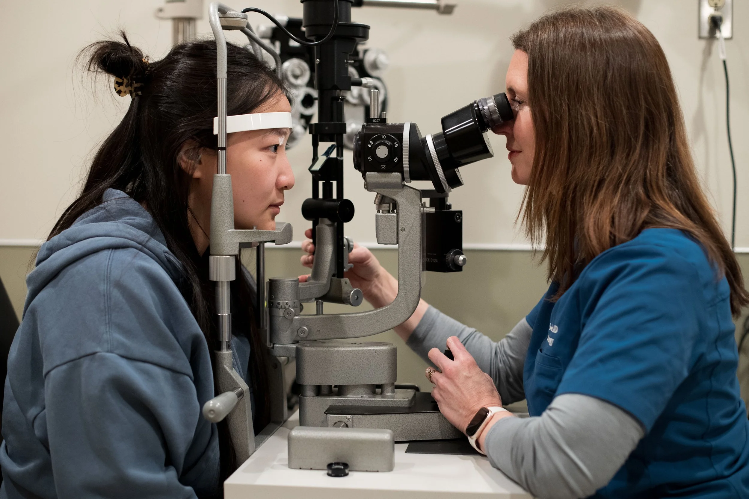 Dr. Seefeldt provides slit lamp comprehensive eye exam to a young woman