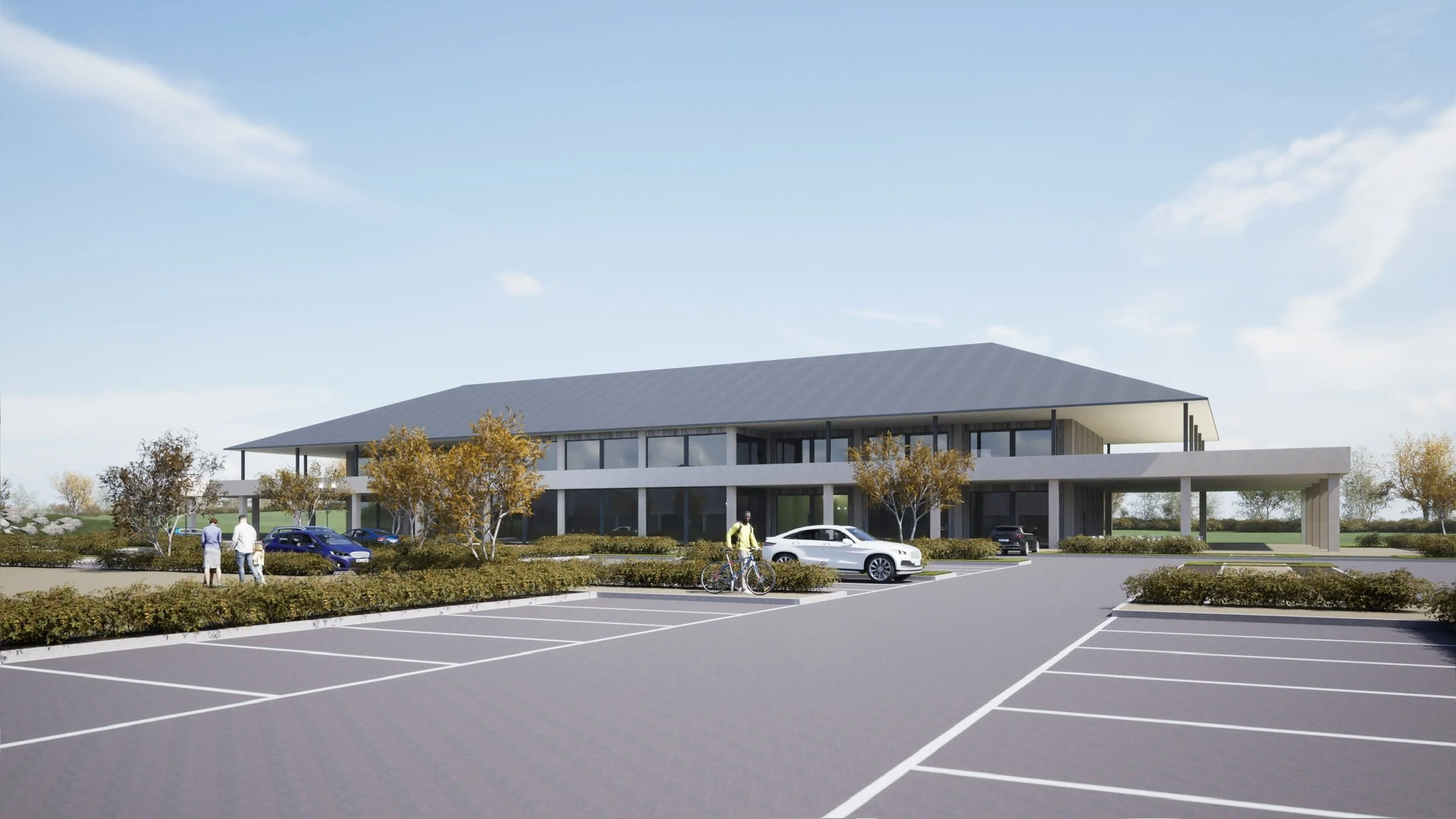 A modern two-story office building with large glass windows and a sloped roof, surrounded by parking spaces, trees, and landscaping, with people walking and a cyclist in the parking lot.