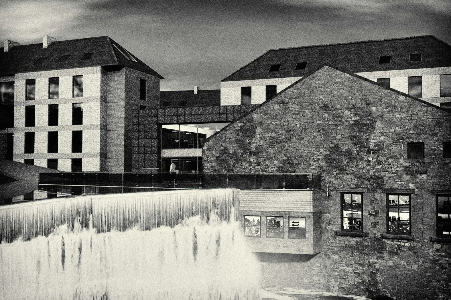 Nighttime black and white photo of modern multi-story buildings with a waterfall feature in the foreground.
