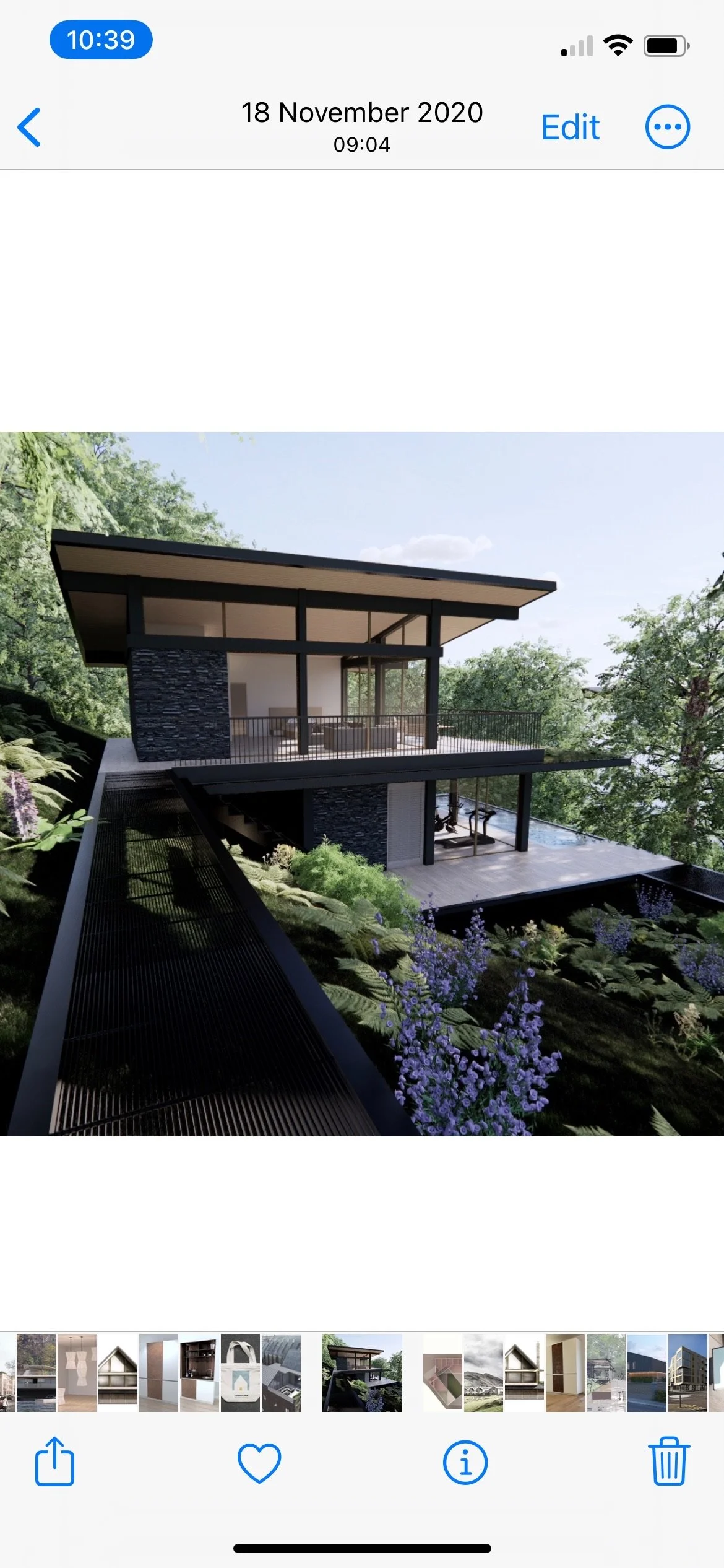 A modern two-story house with large glass windows, black structural elements, a rooftop balcony, and surrounded by green trees and purple flowers.