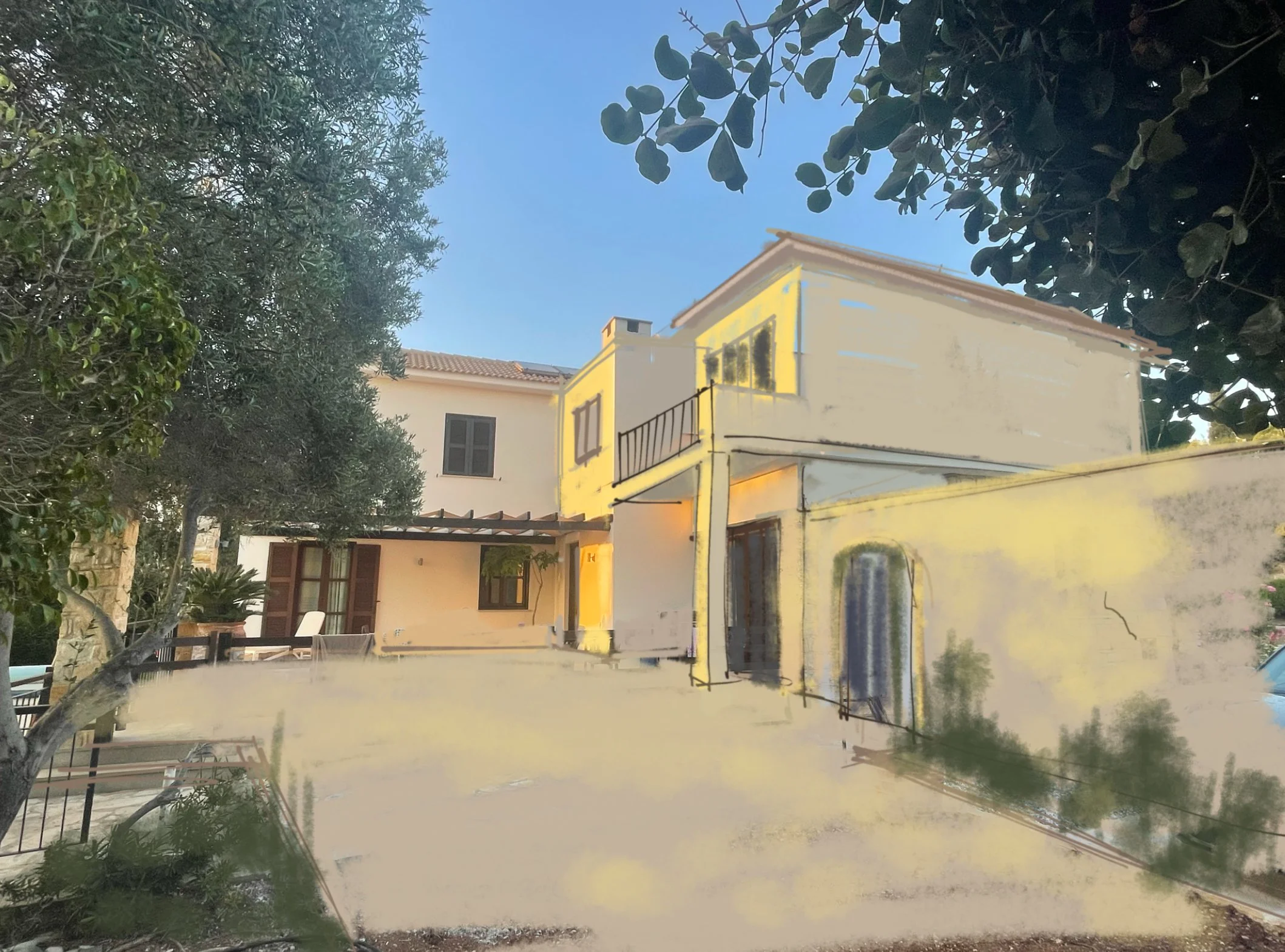 A multi-story house with beige walls and a red-tiled roof, surrounded by trees and plants, with a clear blue sky overhead.