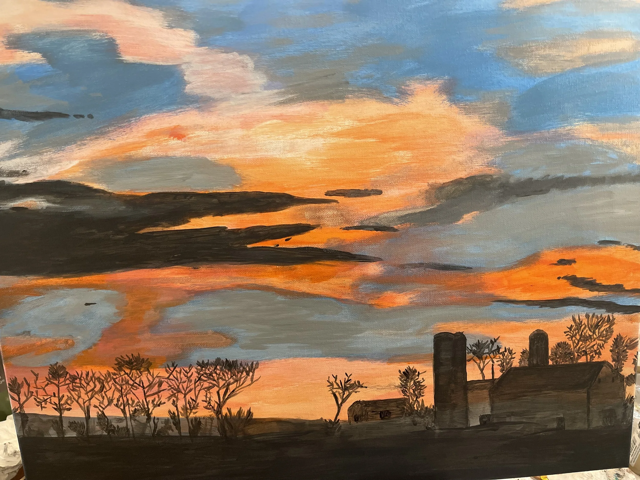 Painting of a farm landscape at sunset, showing the sky with orange, pink, and blue clouds, silhouettes of trees, barn, and silos in the foreground.