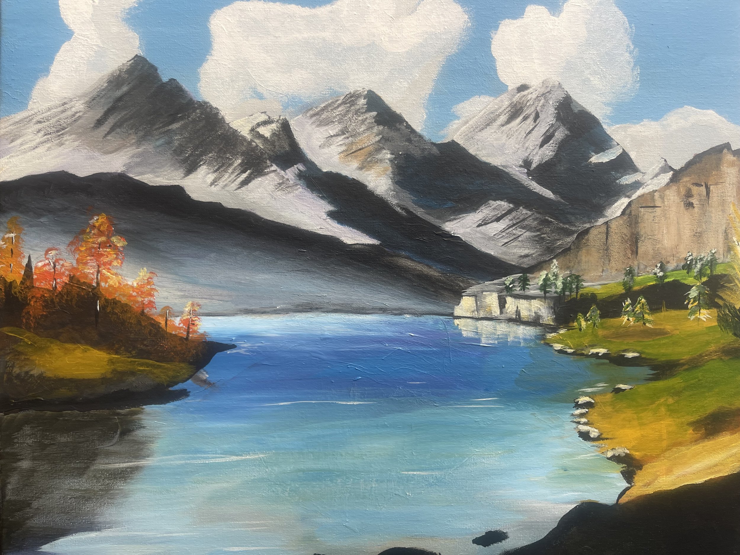 A landscape painting of snow-capped mountains, a river, colorful trees, and green grassy areas with a partly cloudy sky.