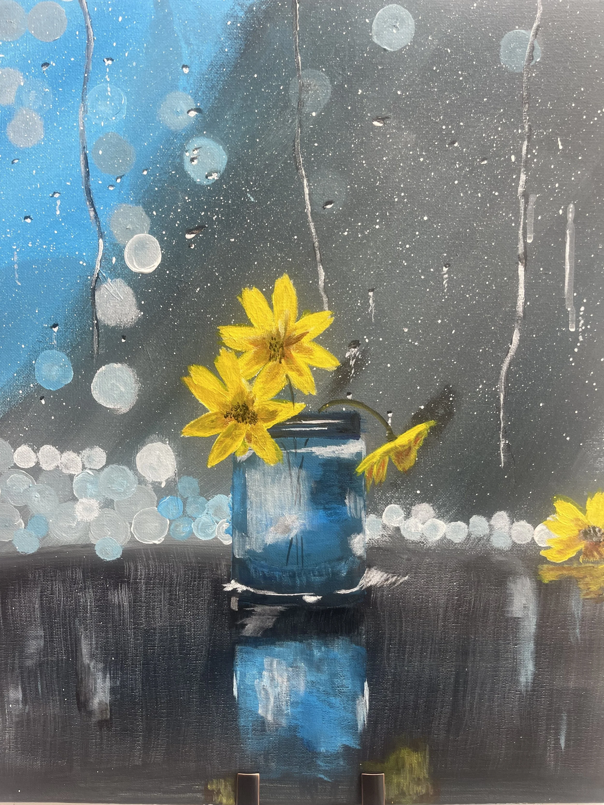 Painting of yellow flowers in a blue glass jar with a rainy window background.