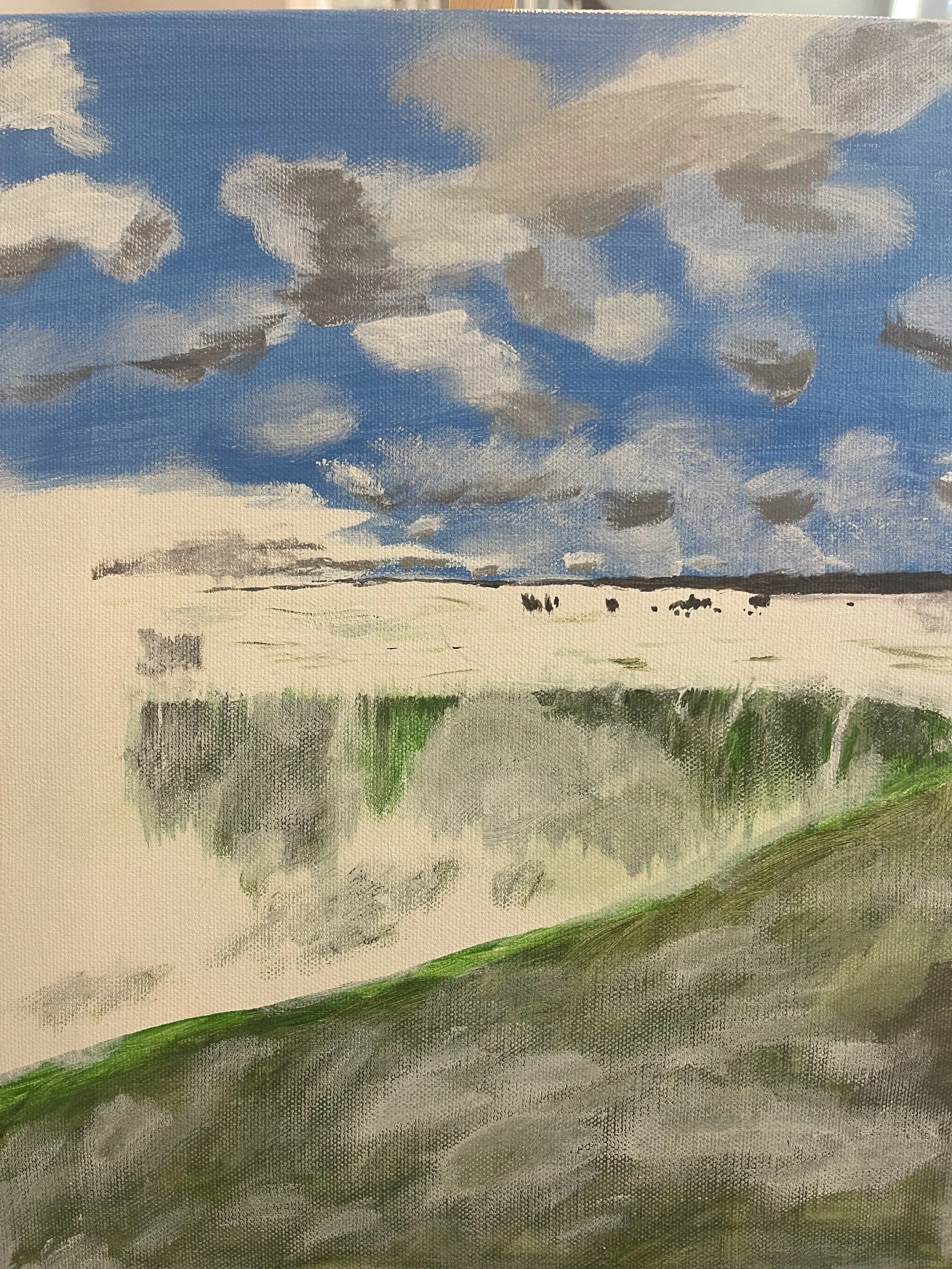 A landscape painting of a cloudy sky, a sandy beach, and green grassy dunes reflected in a body of water.