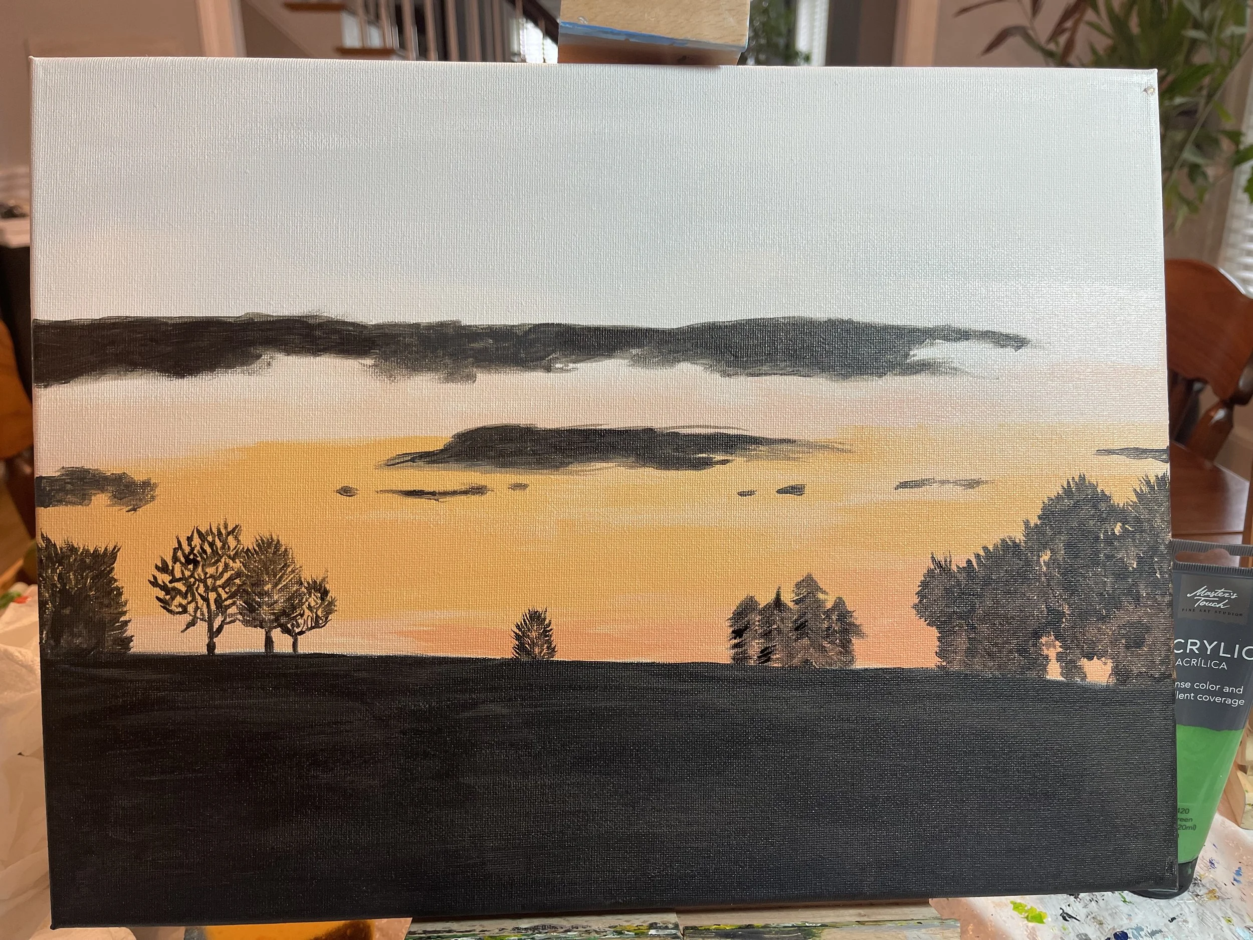 Painted sunset landscape with a black foreground, trees on the left and right, a central tree line, and a sky with dark and light clouds, orange and pink hues.