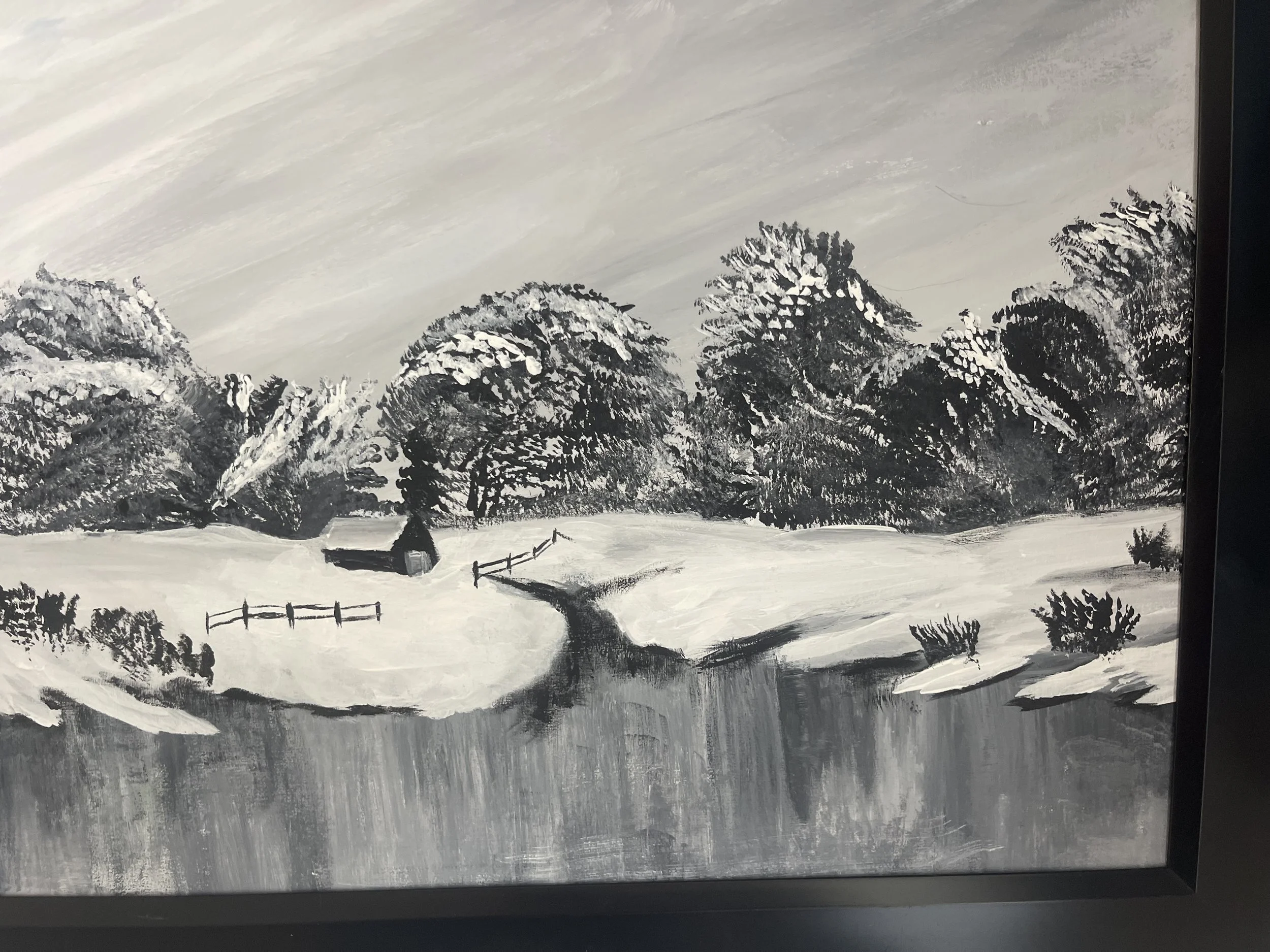 A black and white painting of a winter landscape featuring snow-covered trees, a small house, a winding path, and a body of water reflecting the surroundings.