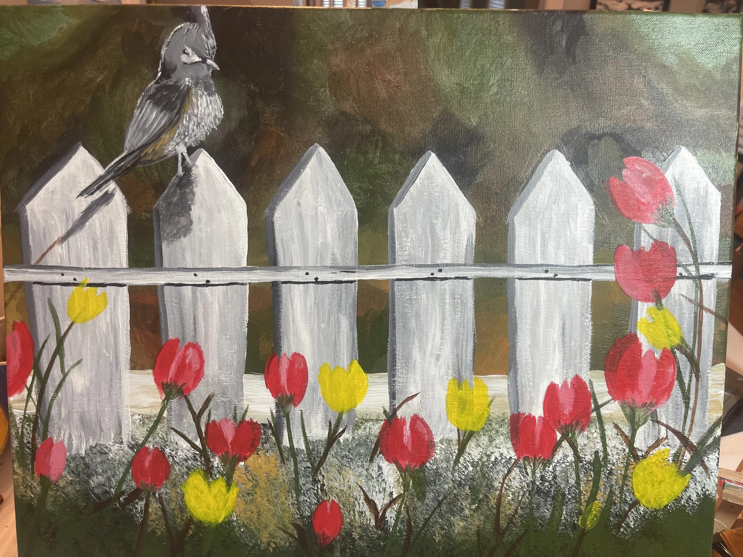 A painted scene of a white picket fence with red and yellow flowers in the foreground and a bird perched on the fence post against a green background.