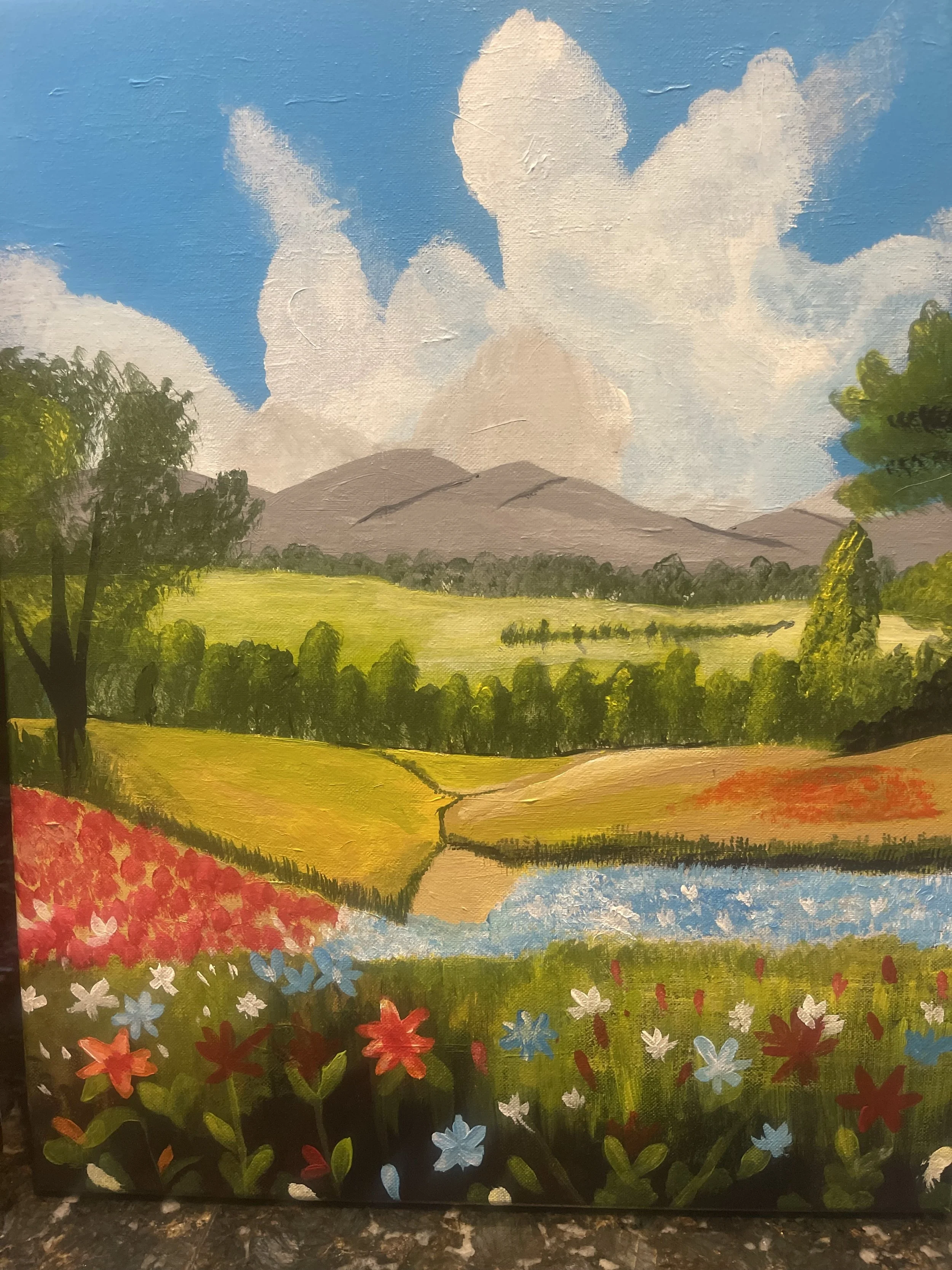 Painting of a scenic landscape with colorful flowers in the foreground, green fields and trees, a winding river, mountains in the background, and a blue sky with large white clouds.