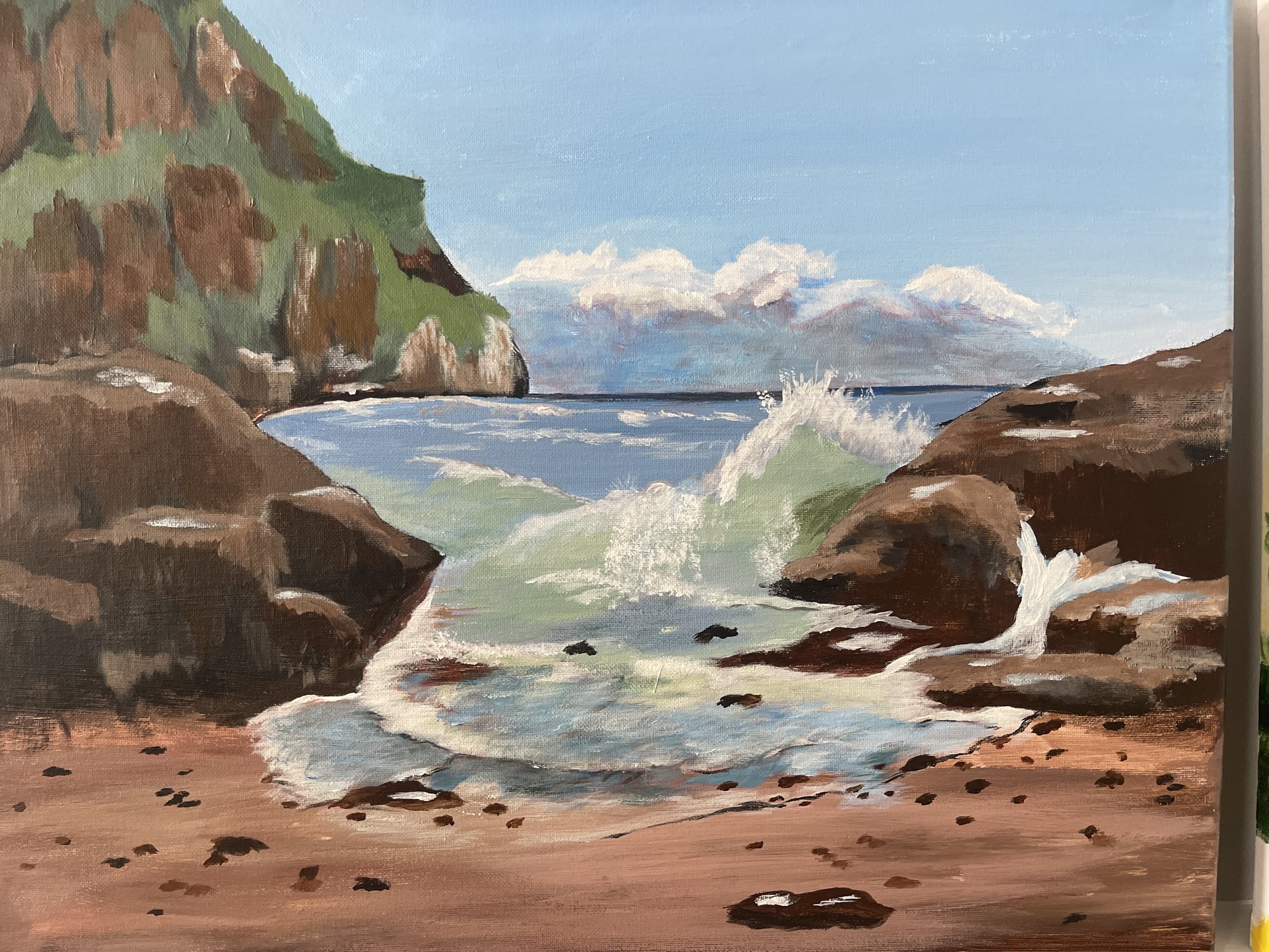 A painting of a rocky shoreline with waves crashing against the rocks, green hills in the background, and a partly cloudy sky.