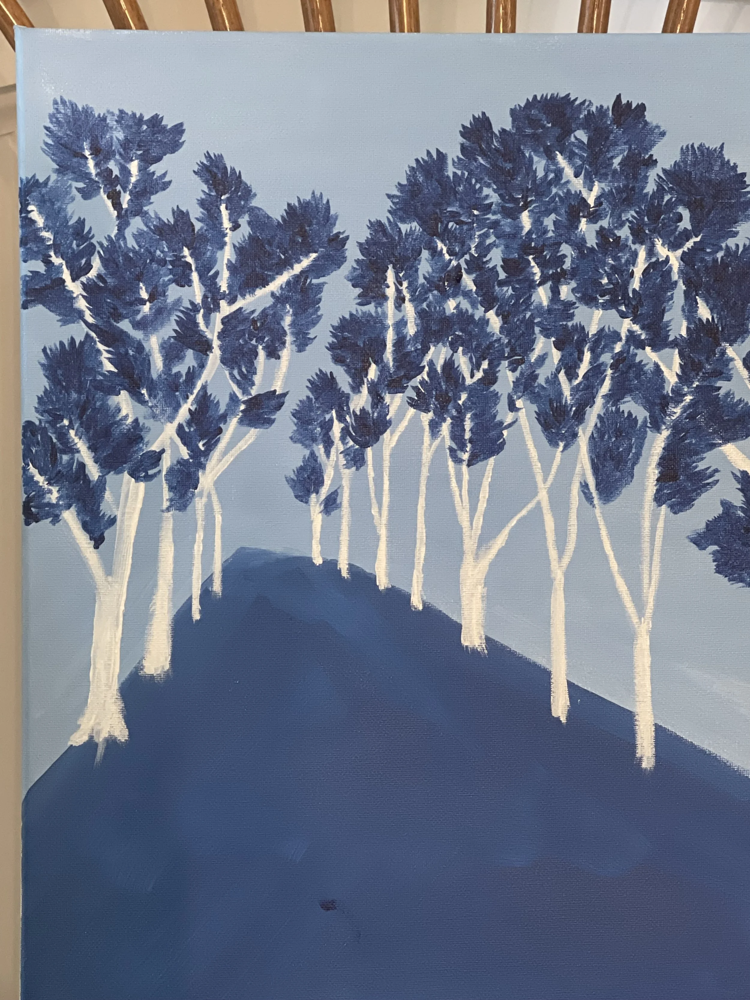 A painting of a group of blue trees with white trunks, arranged on a blue hill against a light blue sky.