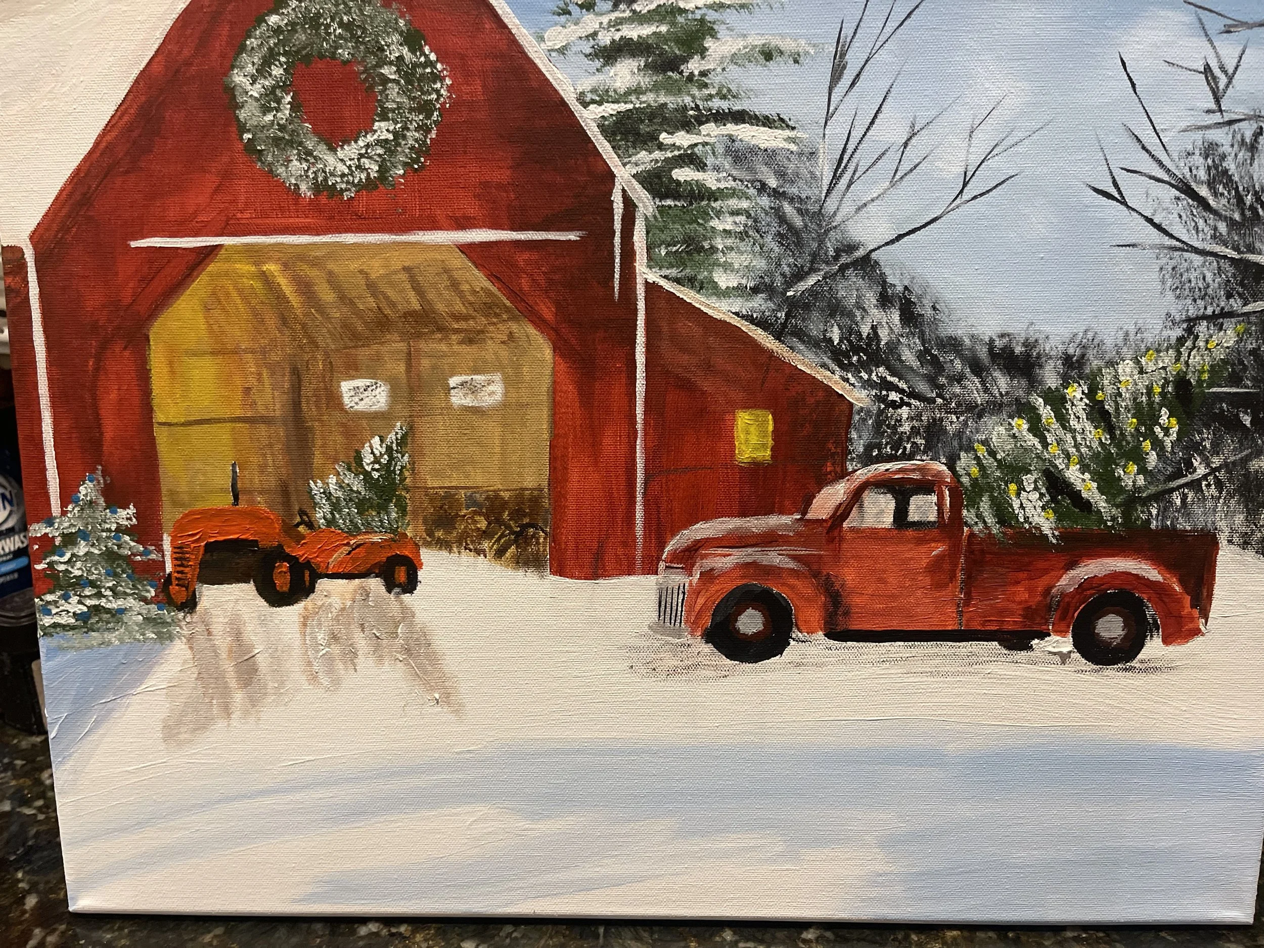 Painting of a winter scene with a red barn decorated with a wreath, a snow-covered landscape, and vintage red trucks parked outside.