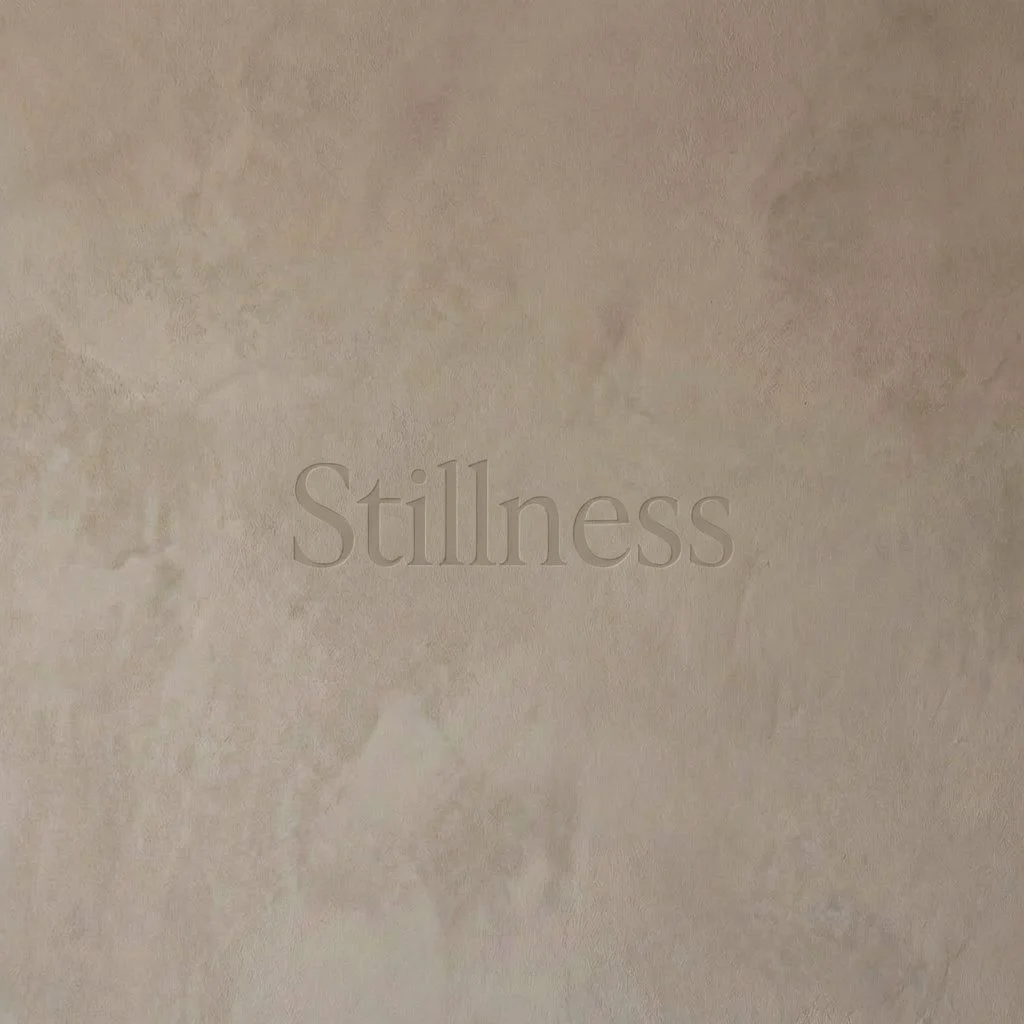 Stillness text on textured beige wall
