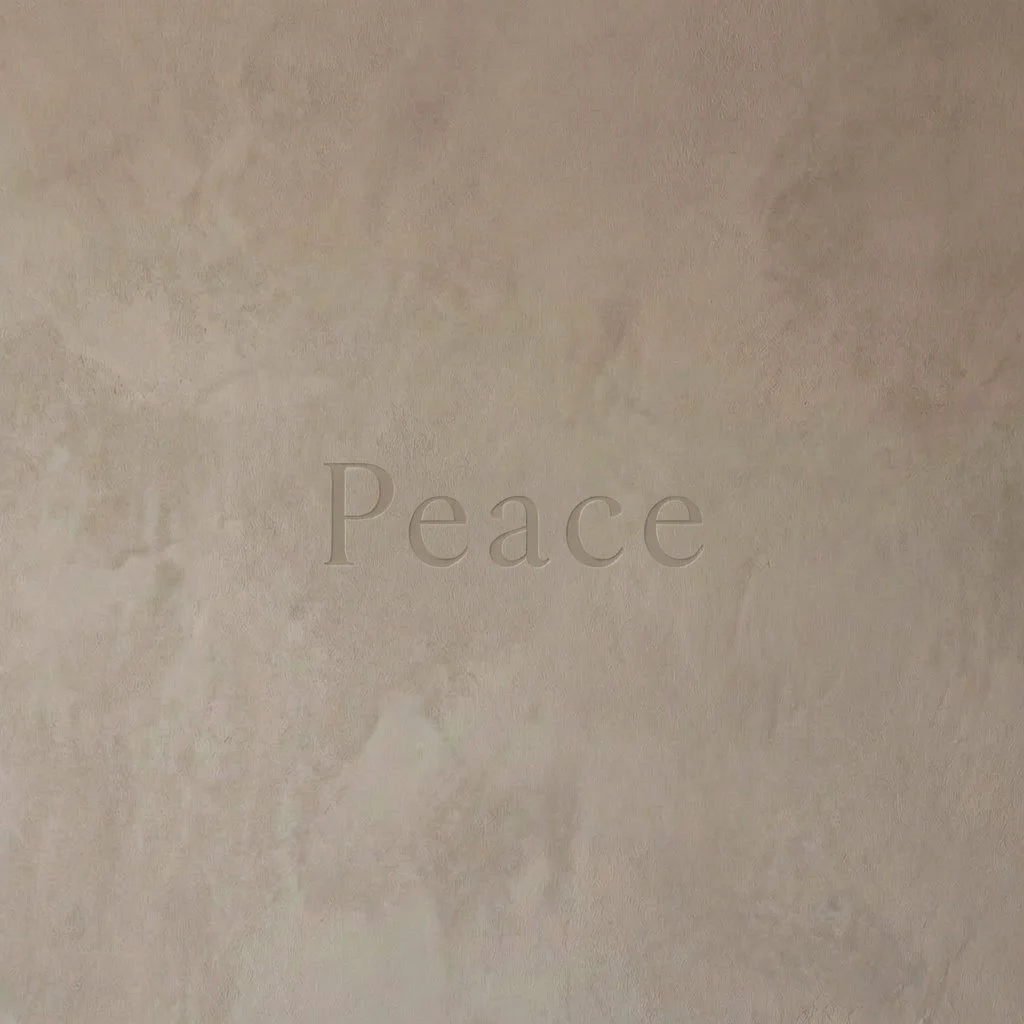 Peace text on textured beige wall