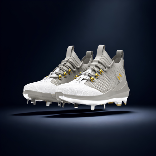 A pair of white Under Armour spiked athletic shoes with yellow accents against a dark background.