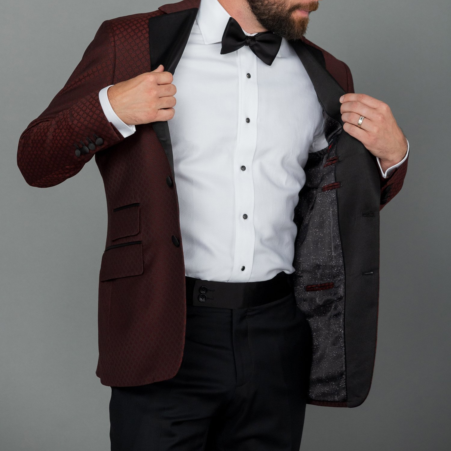 Bespoke black tuxedo with sharp silhouette and refined finish.