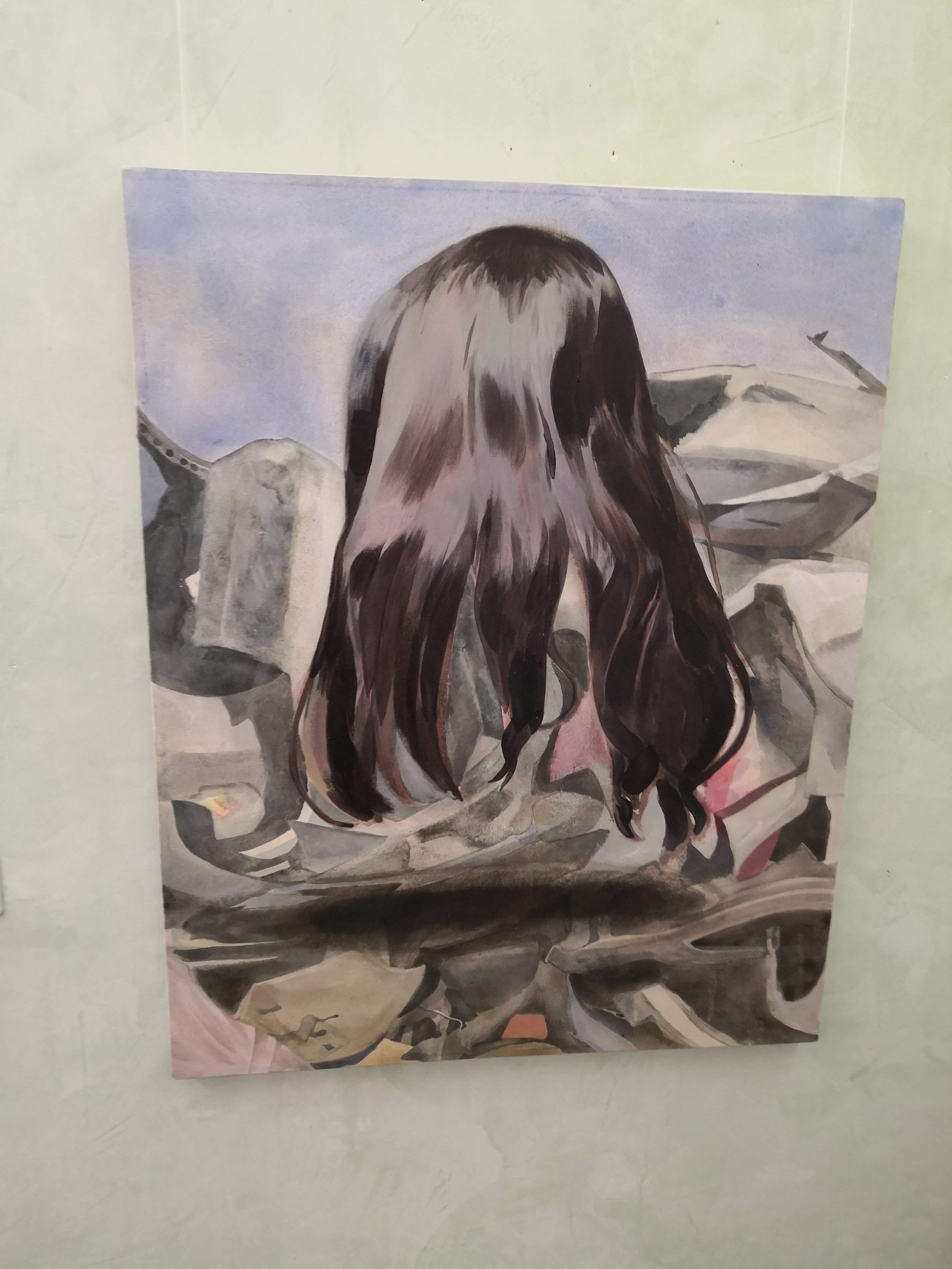 Dipinto di una ragazza con i capelli lunghi e castani vista da dietro, con sfondo di rocce e cielo.