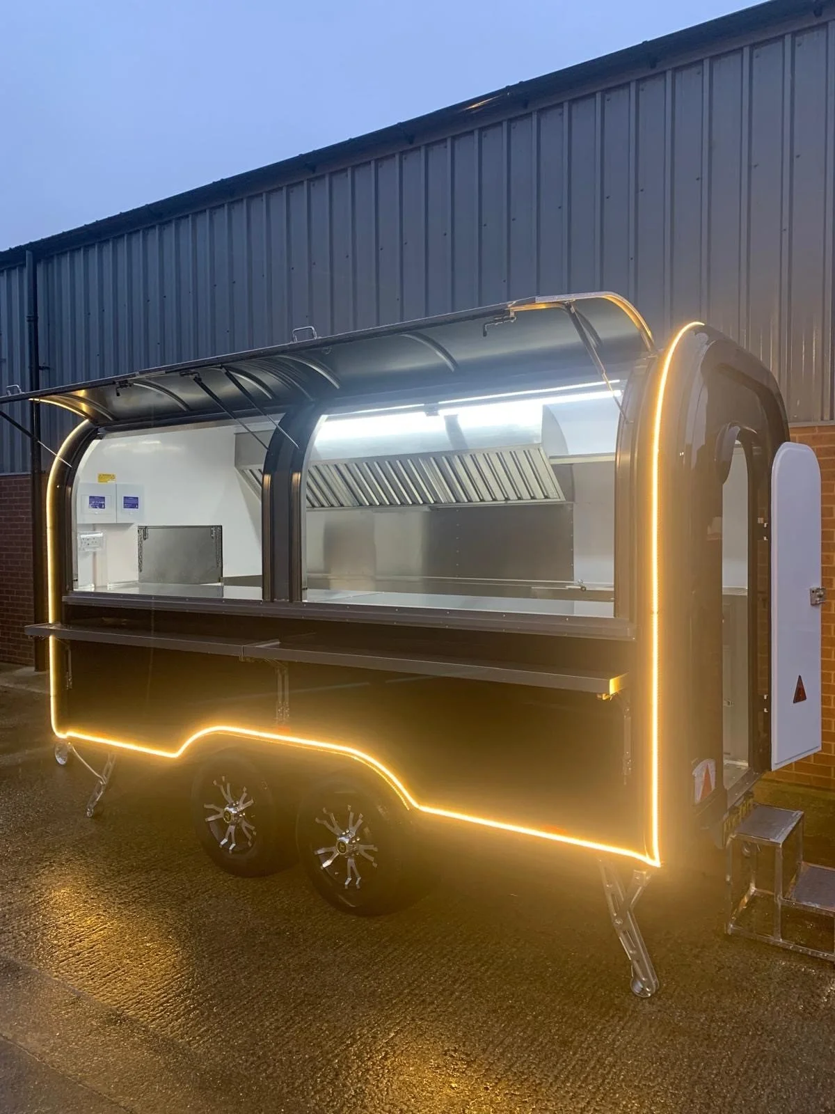 Small photo of an illuminated food serving trailer