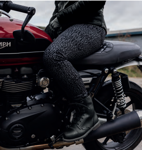 Photo of a lady wearing animal print Oxford trousers on a motorcycle