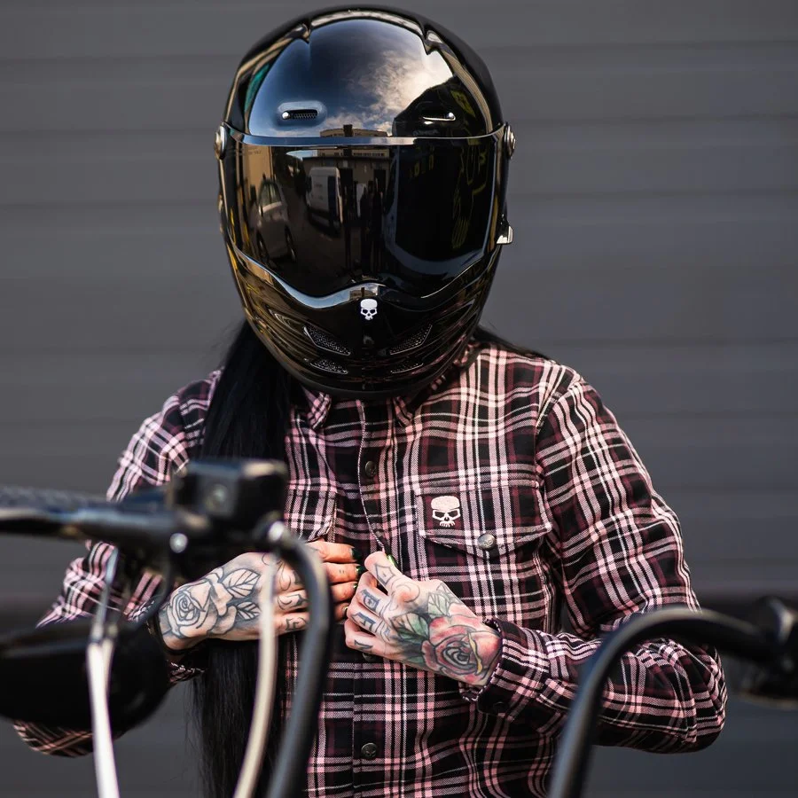 Photo of a female motorcycle rider wearing a pink and black BOBHEAD shirt