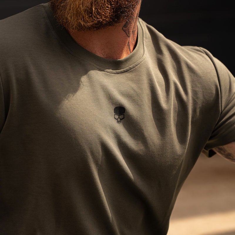 Close-up photo a man wearing a dark green BOBHEAD t-shirt