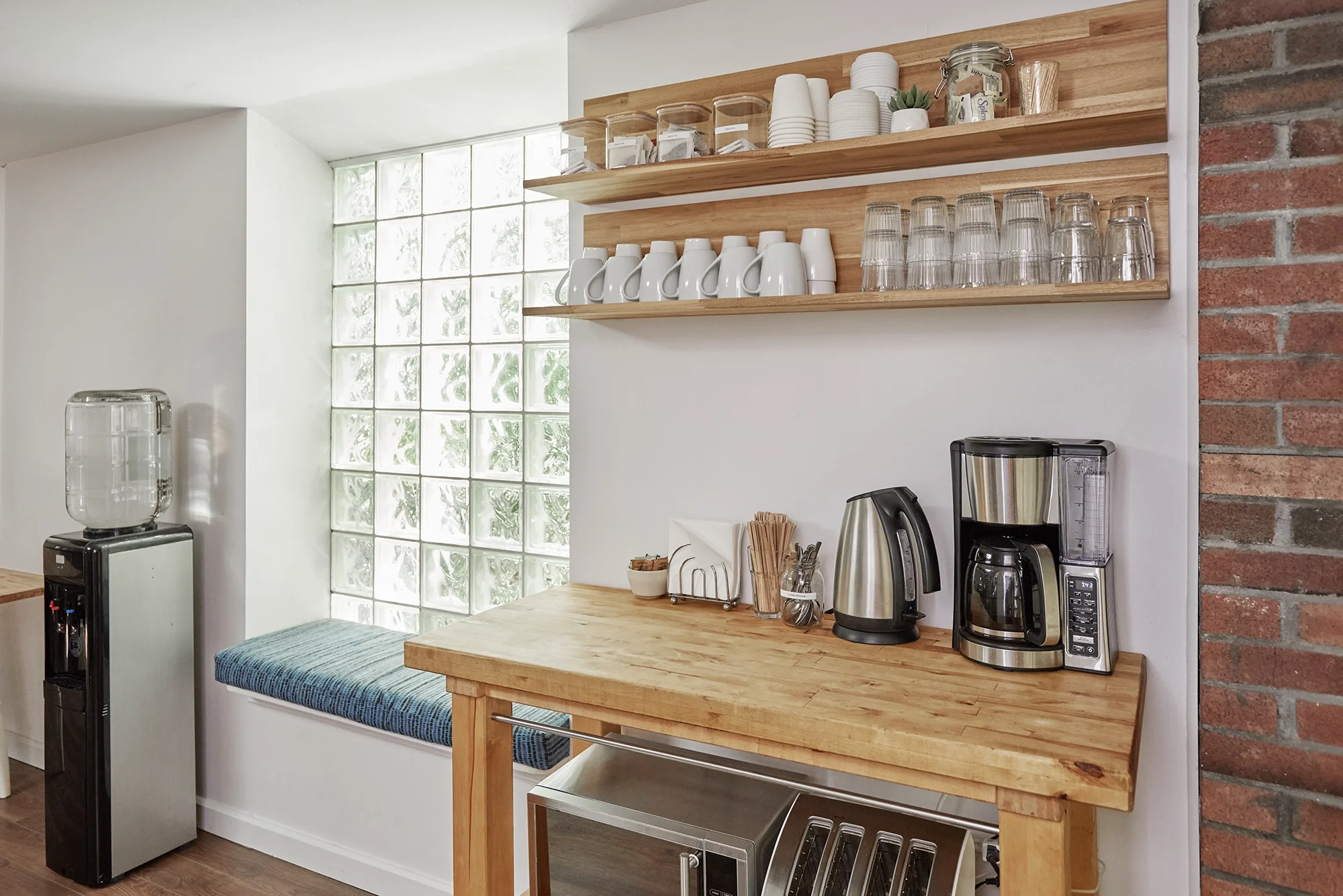 Fully stocked complimentary coffee station and tea bar in the client lounge at Sterling Studio, a Toronto film production rental space.